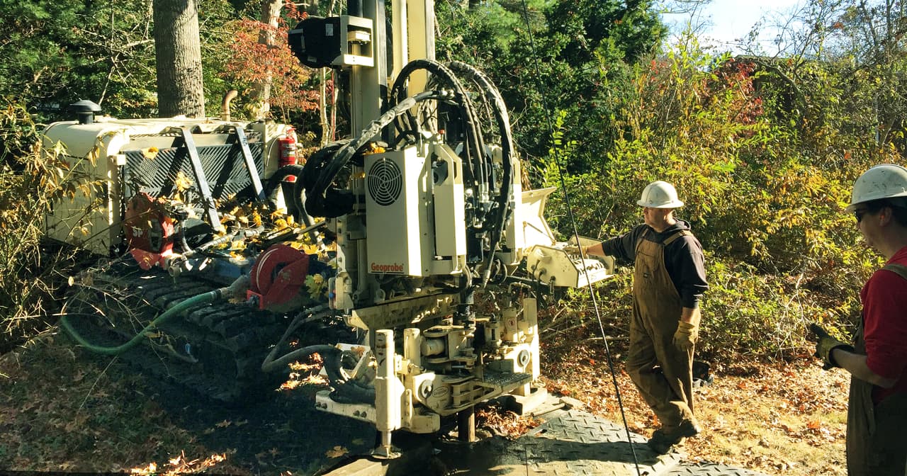 Drillers Russell Neill and Justin Groves of the Environmental Protection Agency EPA Office of Research and Development install monitoring wells with a sonic rig in Barnstable, Massachusetts. 