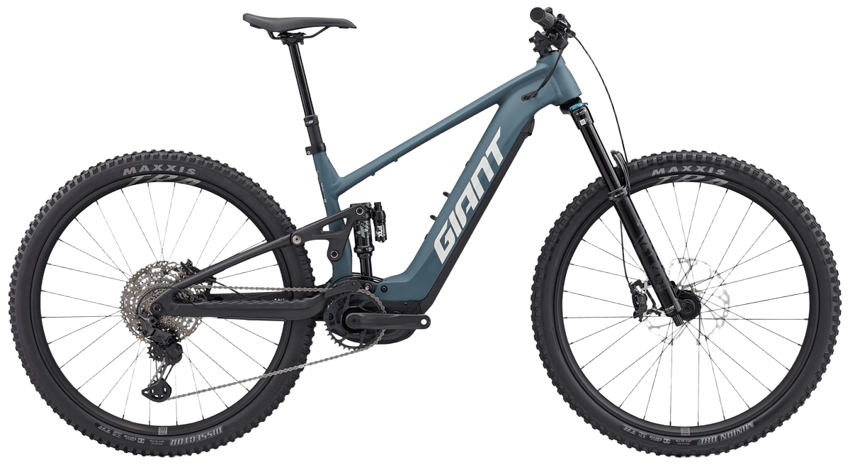 A teal blue Giant electric mountain bike with full suspension and knobby tires.