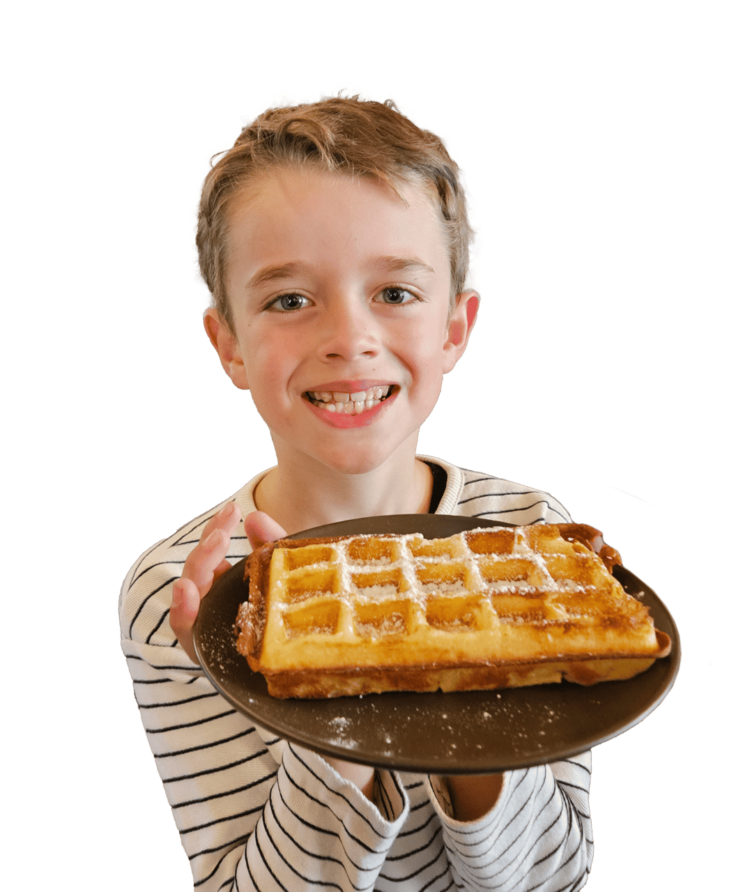 Smiling boy holding a waffle on a plate.