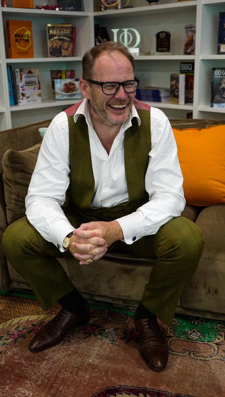 Portrait, Human figure, Vest, Slacks, Button-up shirt, Eyeglasses, Laughing, Sofa, Bookcase