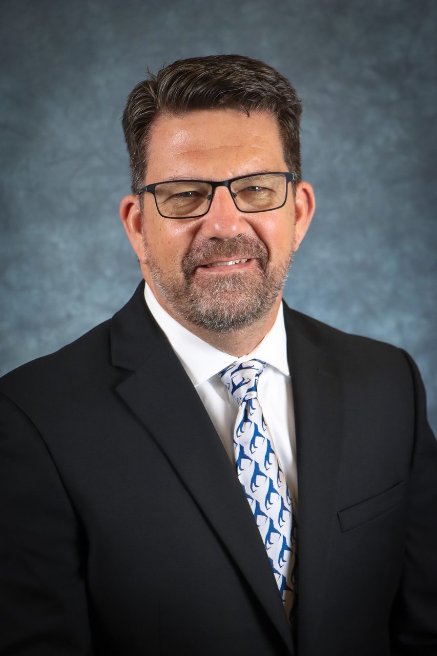 Headshot, Portrait, Suit, Glasses, Facial hair, Tie, Dress shirt, Smile