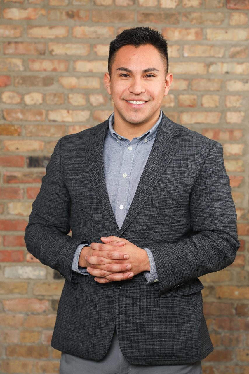Suit trousers, Dress shirt, Clothing, Forehead, Smile, Chin, Outerwear, Sleeve, Gesture, Grey