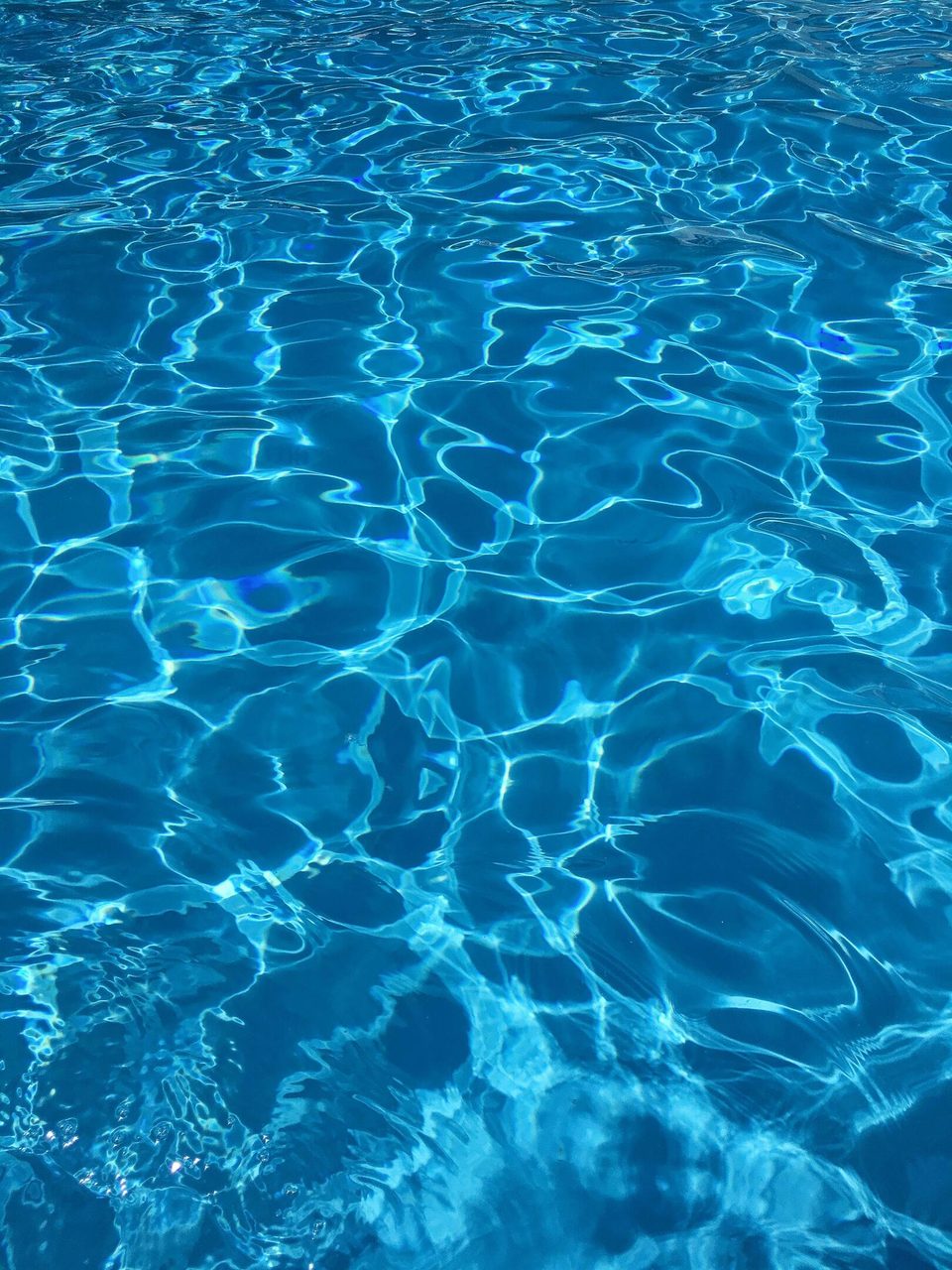 Vibrant blue swimming pool water with dynamic reflections, ideal for abstract backgrounds.. Matthias Cooper: https://www.pexels.com/@mattycphoto