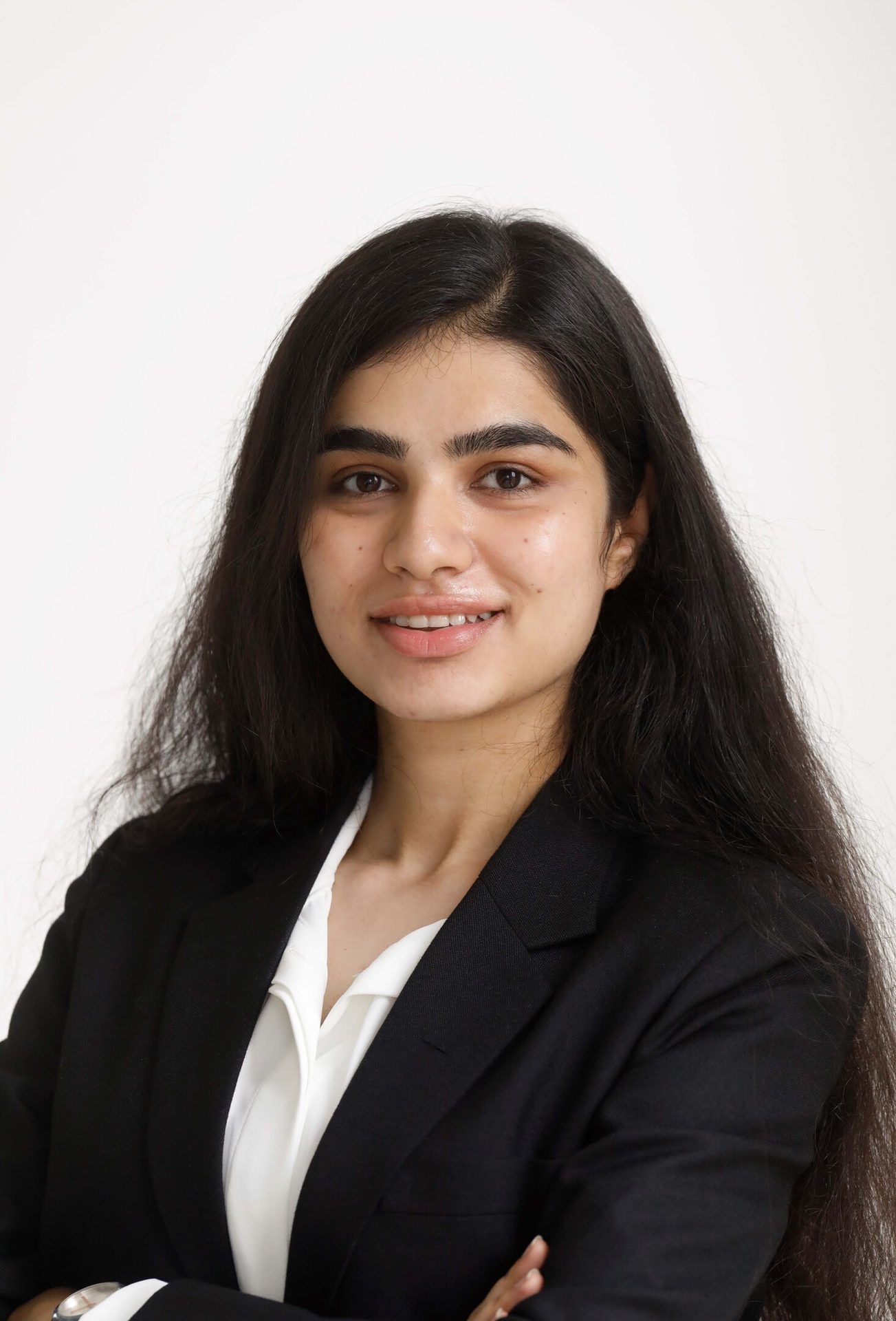 Smiling young woman with dark hair in a black blazer.