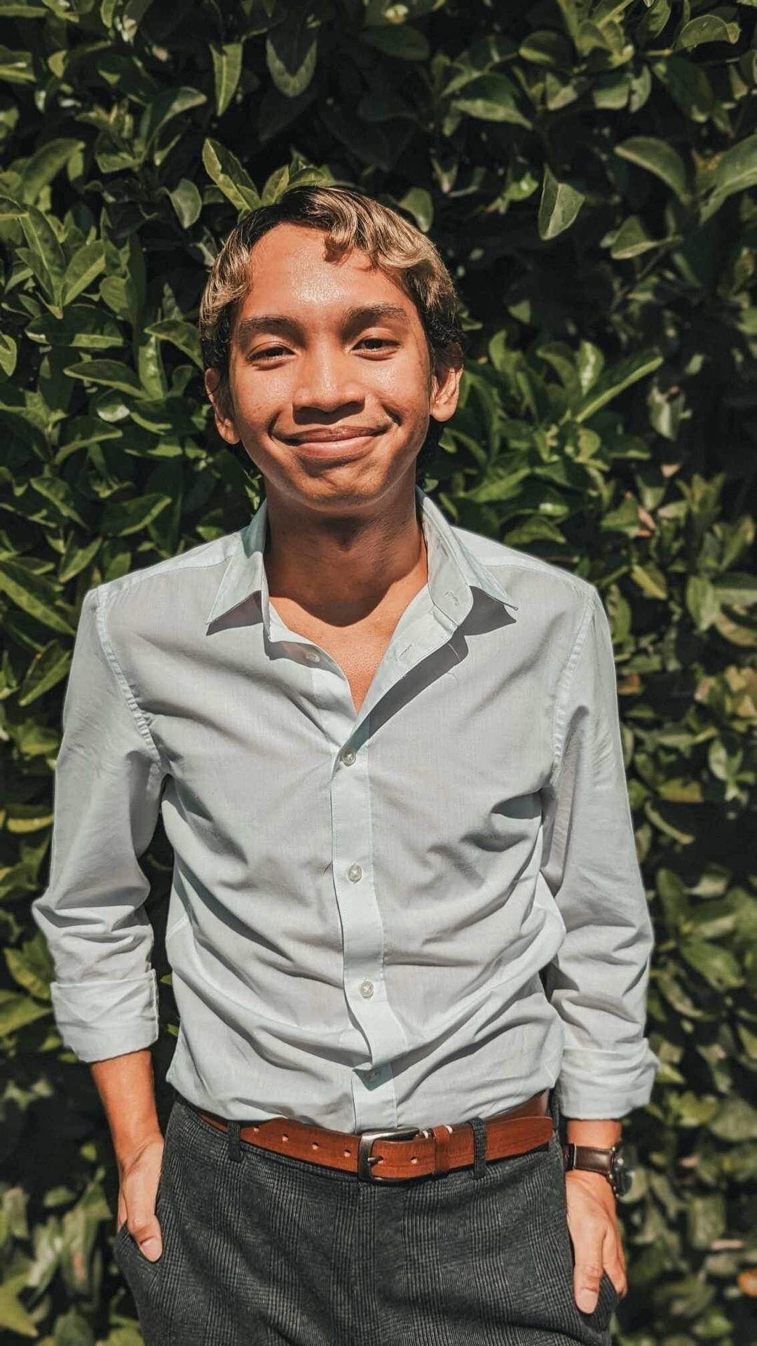 Facial expression, Dress shirt, Clothing, Forehead, Chin, Smile, Black, Human, Neck, Sleeve