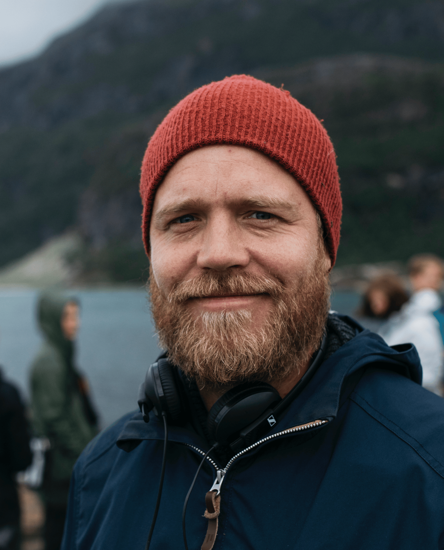 Clothing, Forehead, Chin, Outerwear, Hairstyle, Water, Beard, Cap, Headgear, Smile