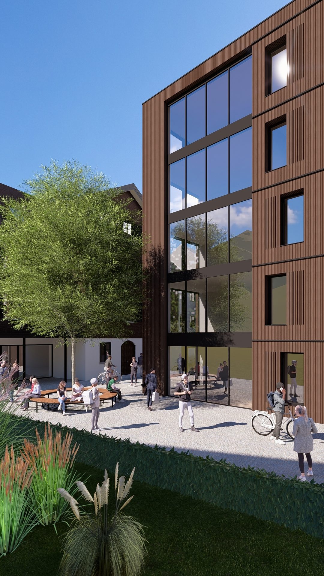 Modern building with large windows overlooking a bustling outdoor courtyard with people, benches, and trees.