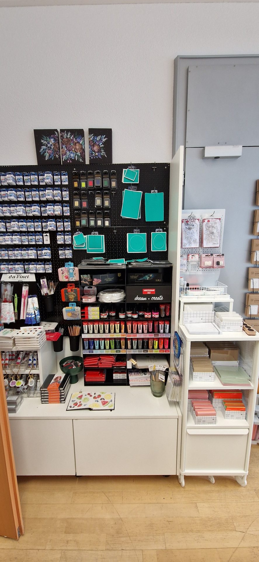 Art supply store display with paints, stencils, brushes, and paper.