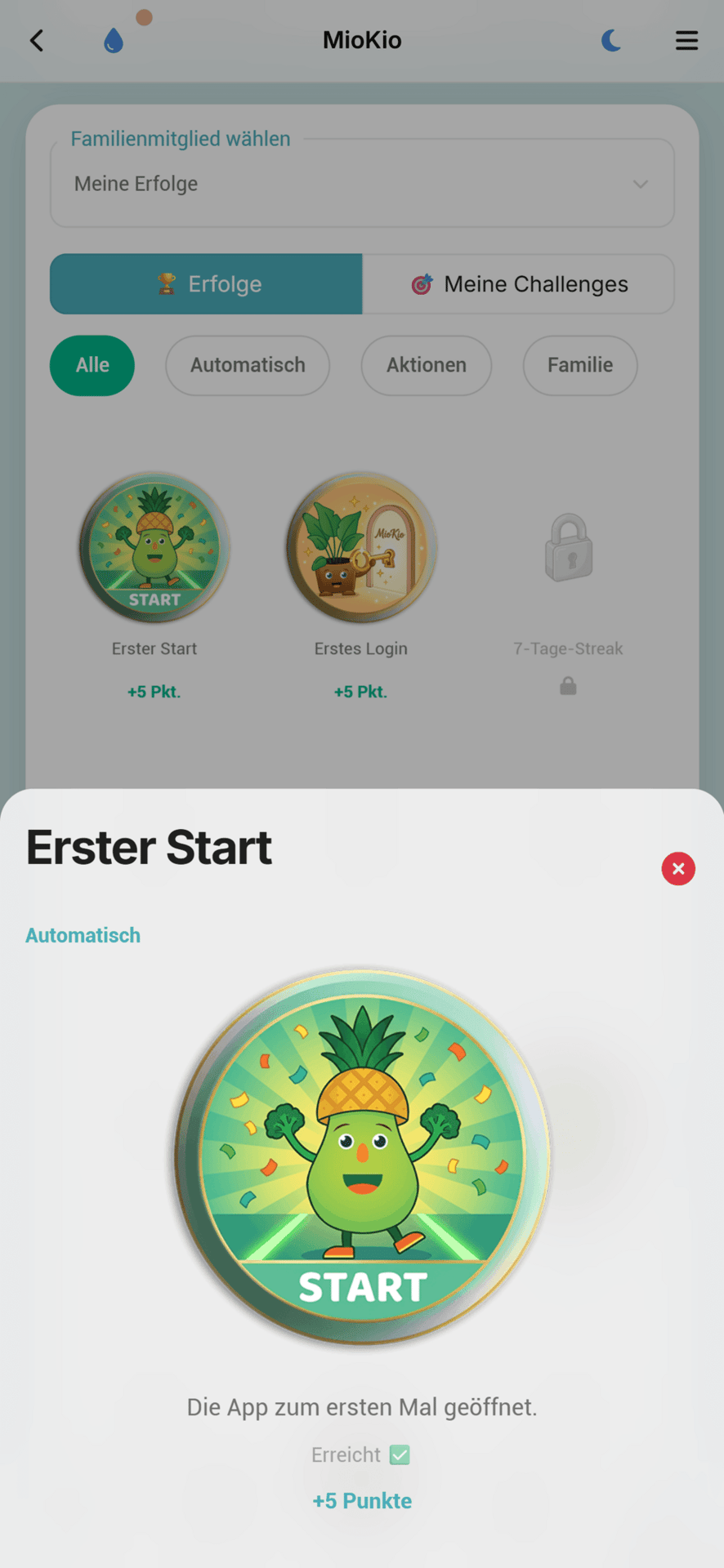 A MioKio mobile app screen displaying an "Erster Start" achievement pop-up with a green avocado character.