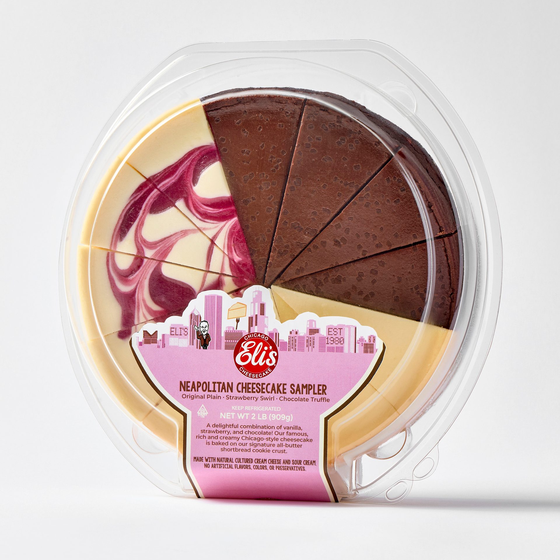 Eli's Neapolitan Cheesecake Sampler with slices of plain, strawberry swirl, and chocolate truffle cheesecake.