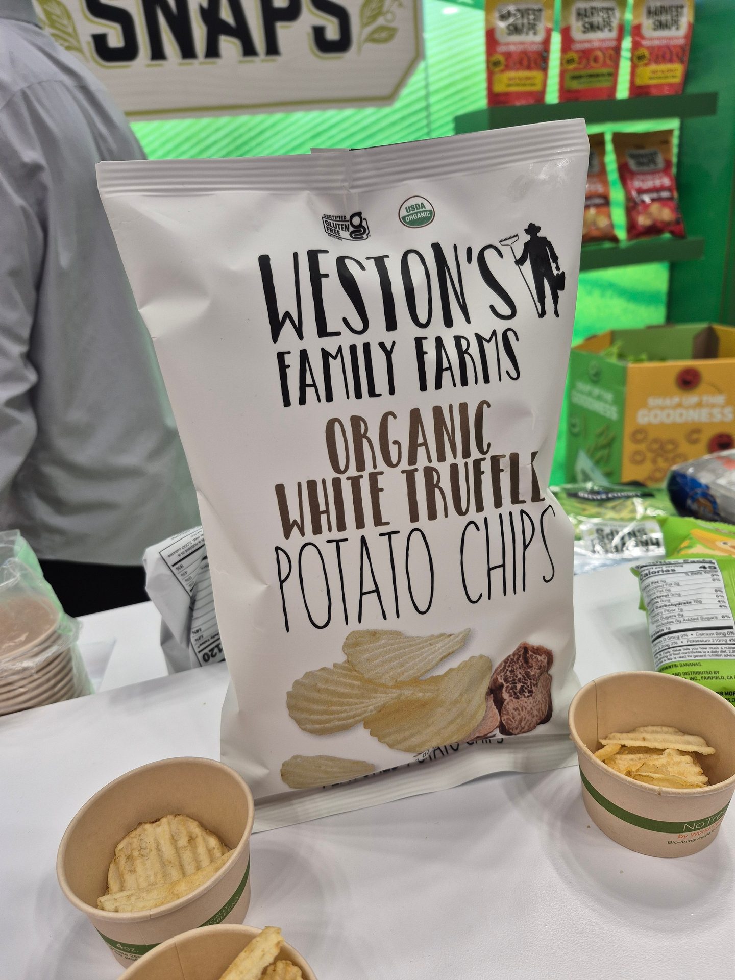 Weston’s Family Farms Organic White Truffle Potato Chips in a white bag at the 2025 Sweets & Snacks Expo