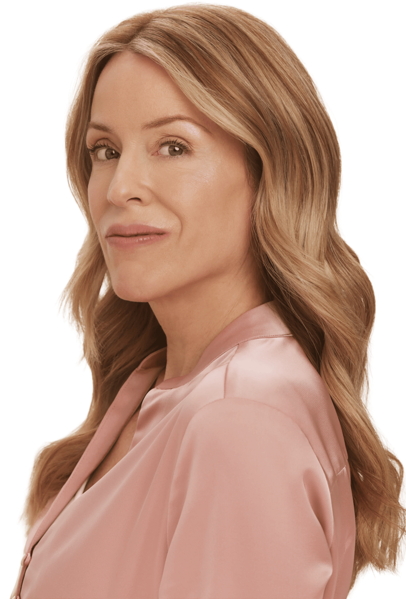 A beautiful woman with long wavy blonde hair and a pink satin top looks at the camera with a gentle smile.