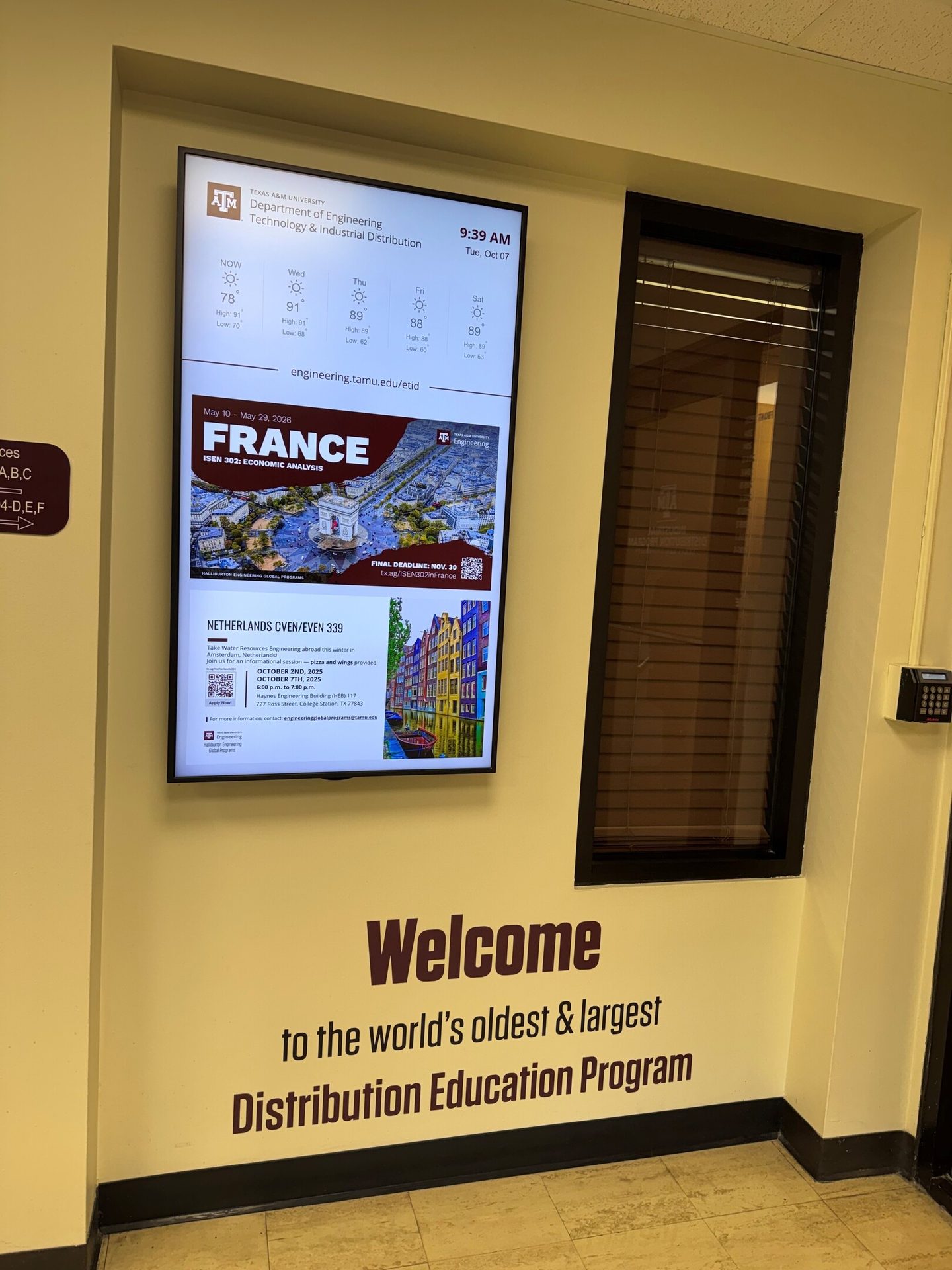 Digital display shows weather, study abroad programs for France and Netherlands, plus a welcome message.