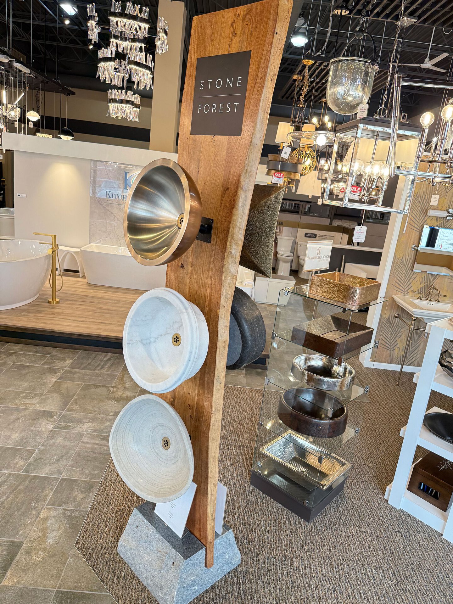 Showroom featuring 'Stone Forest' sinks and other bathroom/kitchen fixtures.