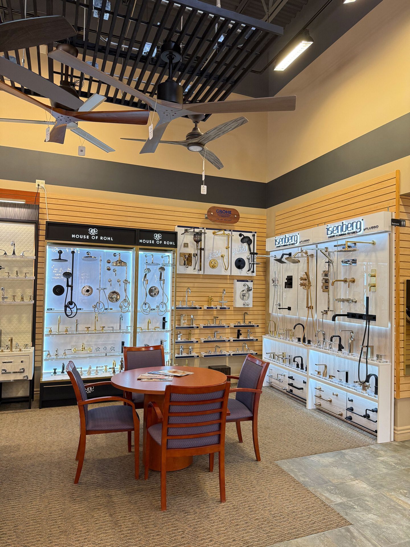 Showroom displaying ceiling fans and various plumbing fixtures from brands like House of Rohl and Isenberg.
