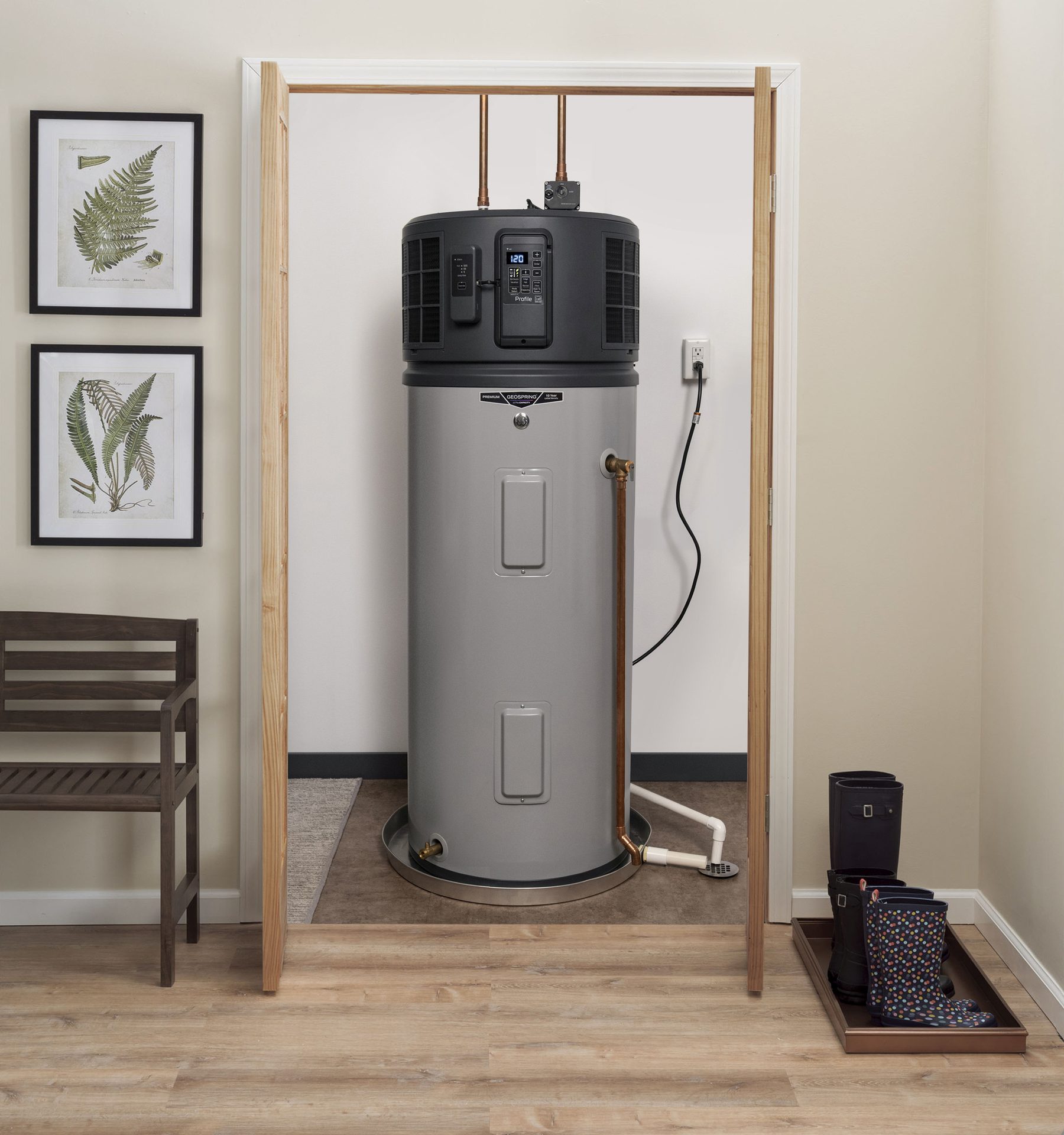 A modern heat pump water heater inside an open utility closet.