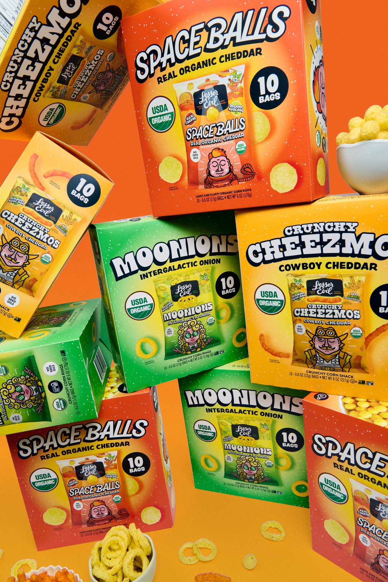 A vibrant display of LesserEvil organic snacks: Space Balls, Cheezmos, and Moonions in colorful boxes.