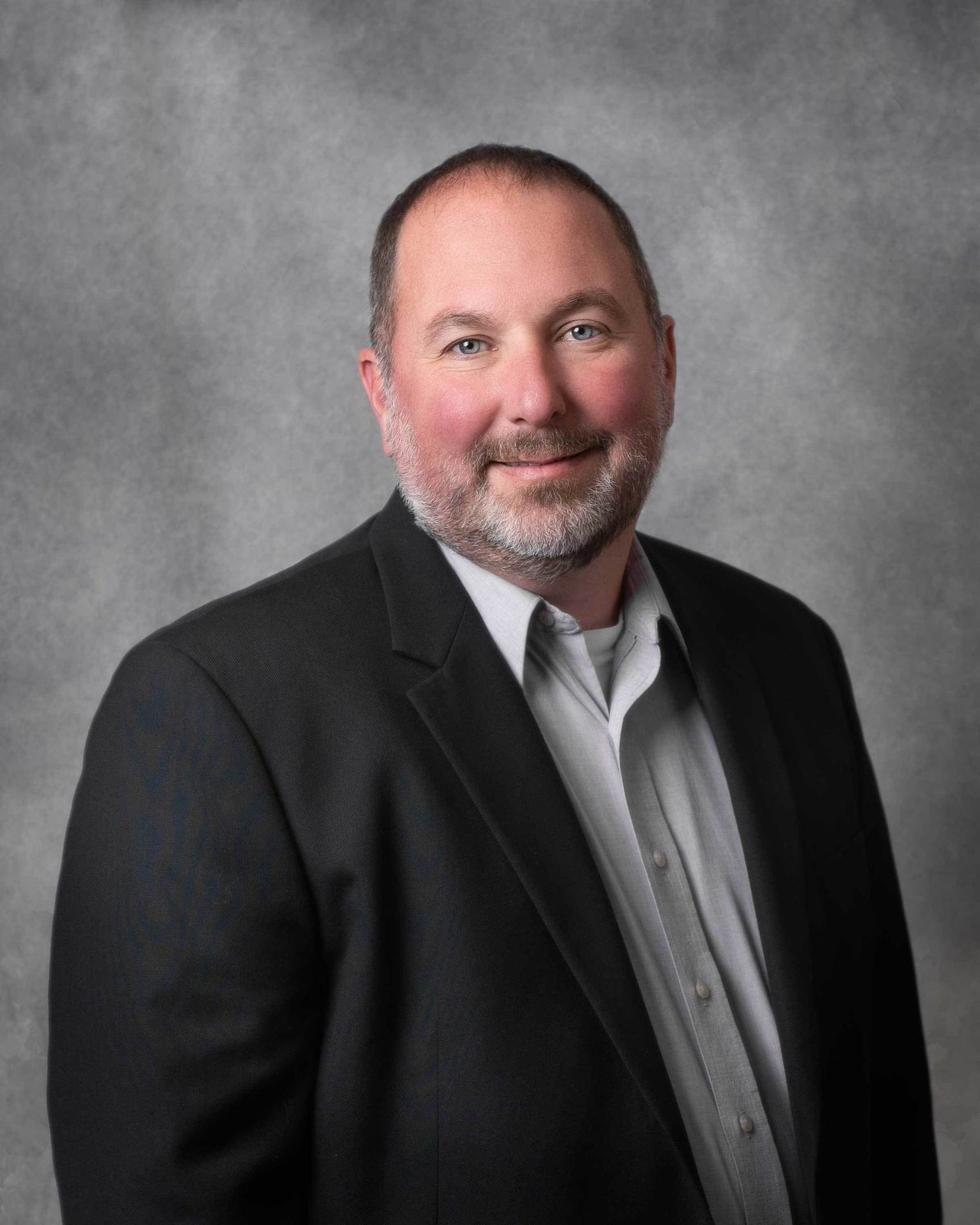 Dress shirt, Flash photography, Forehead, Smile, Eyebrow, Beard, Sleeve, Coat, Grey