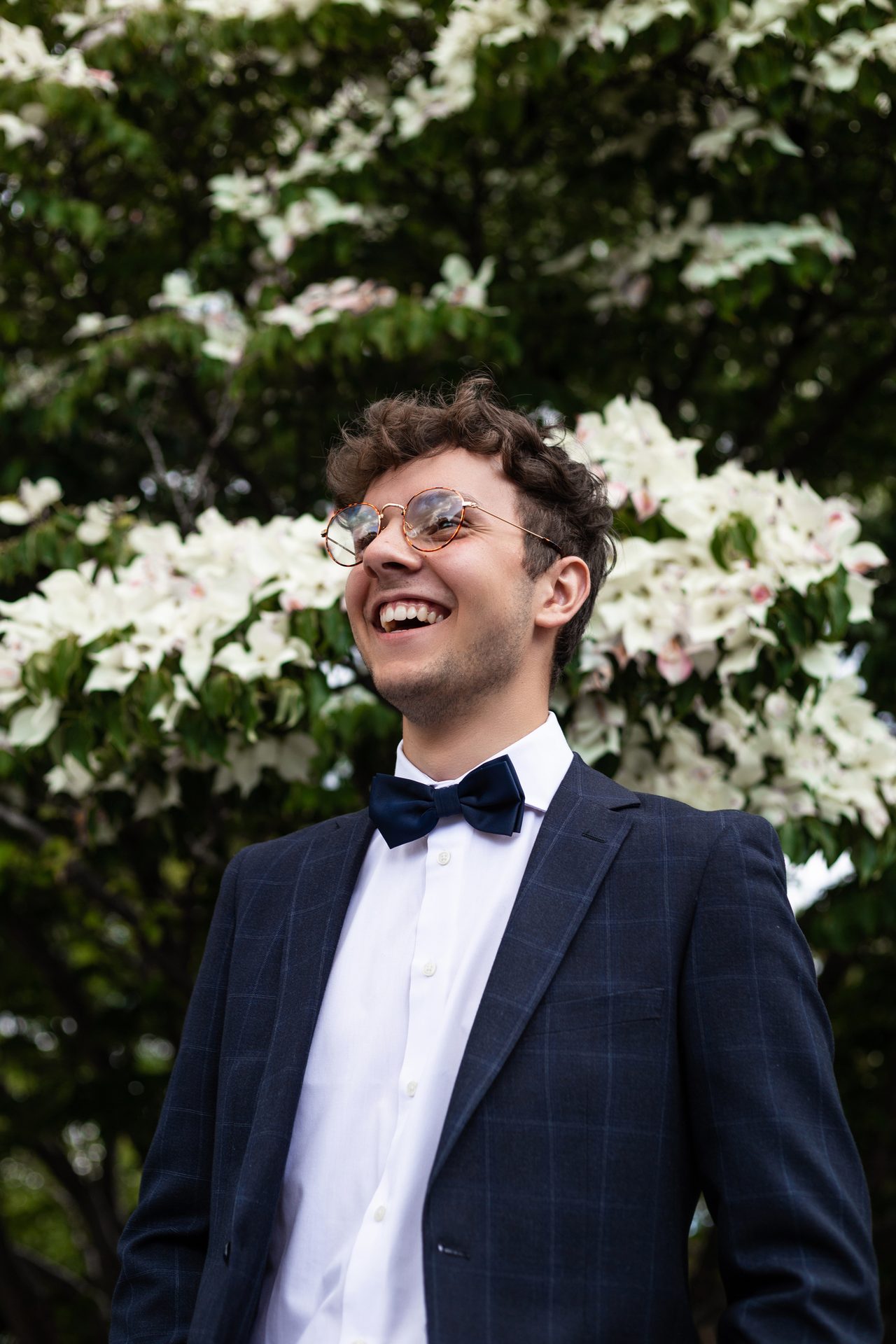 Facial expression, Bow tie, Dress shirt, Smile, Glasses, Flower, Hairstyle, Plant, Fashion
