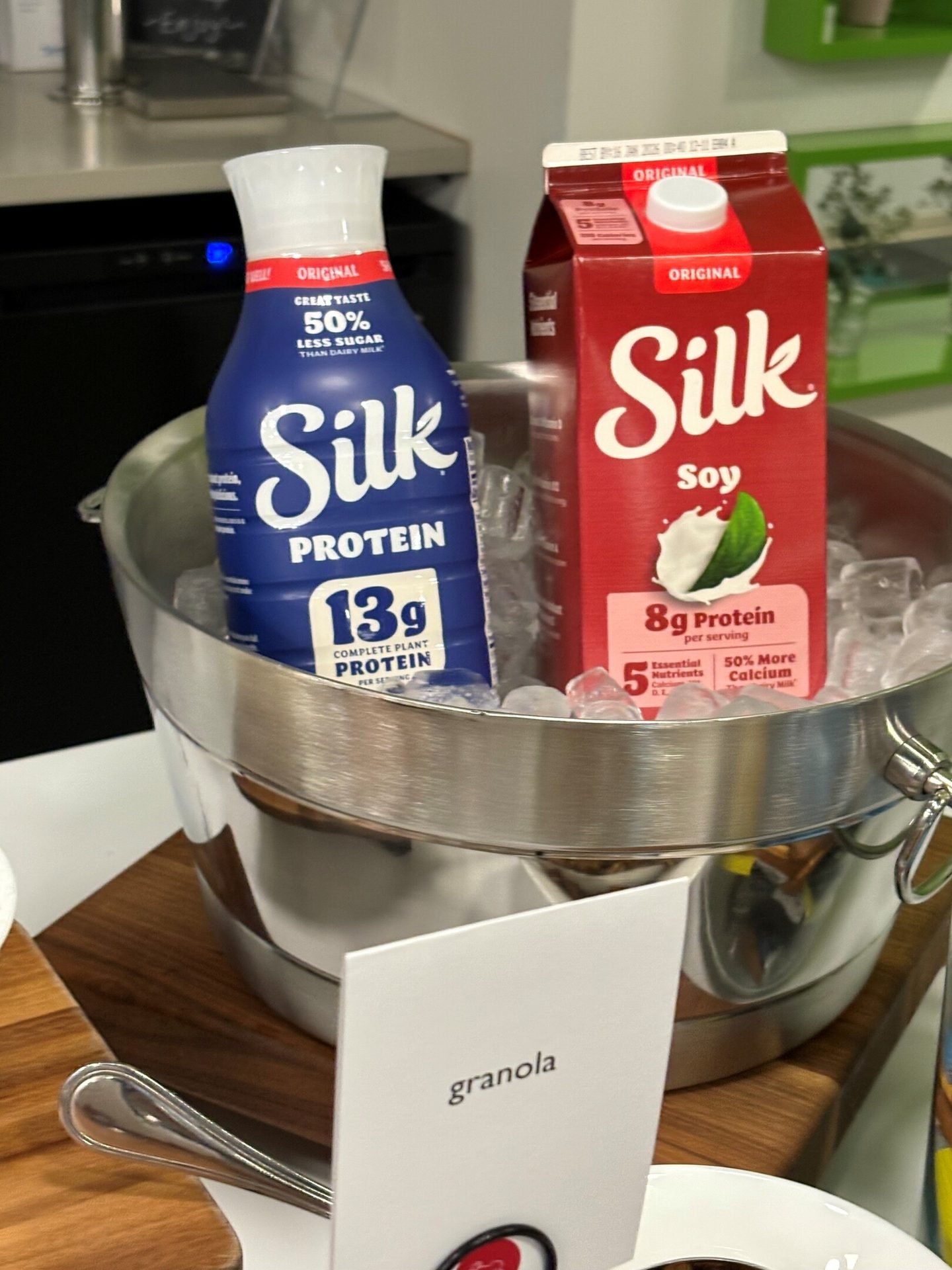 Two Silk Protein and Soy milks in an ice bucket, next to a "granola" sign.
