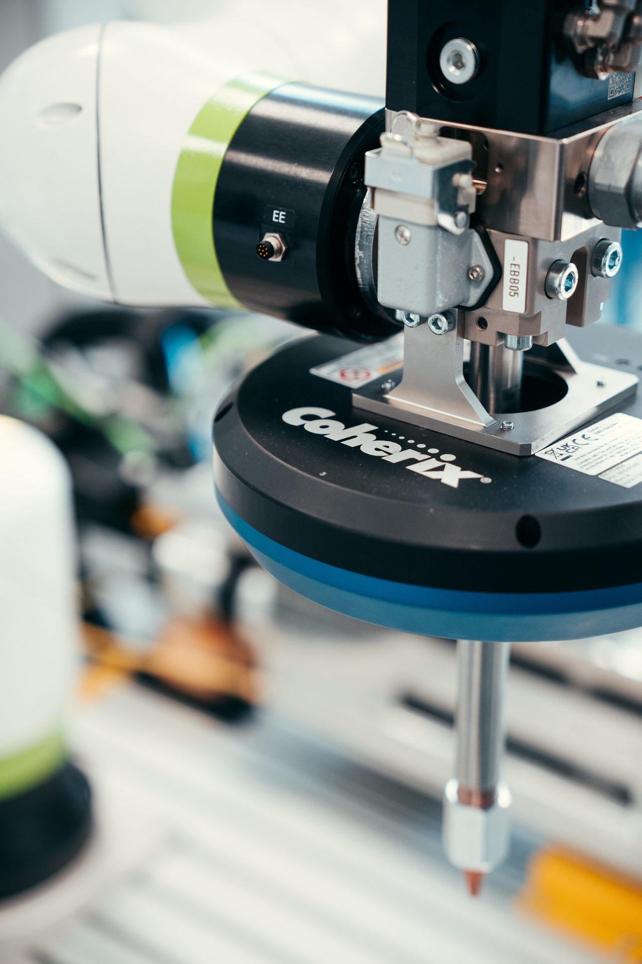 Close-up of a precision industrial robotic arm with a Coherix end-effector.