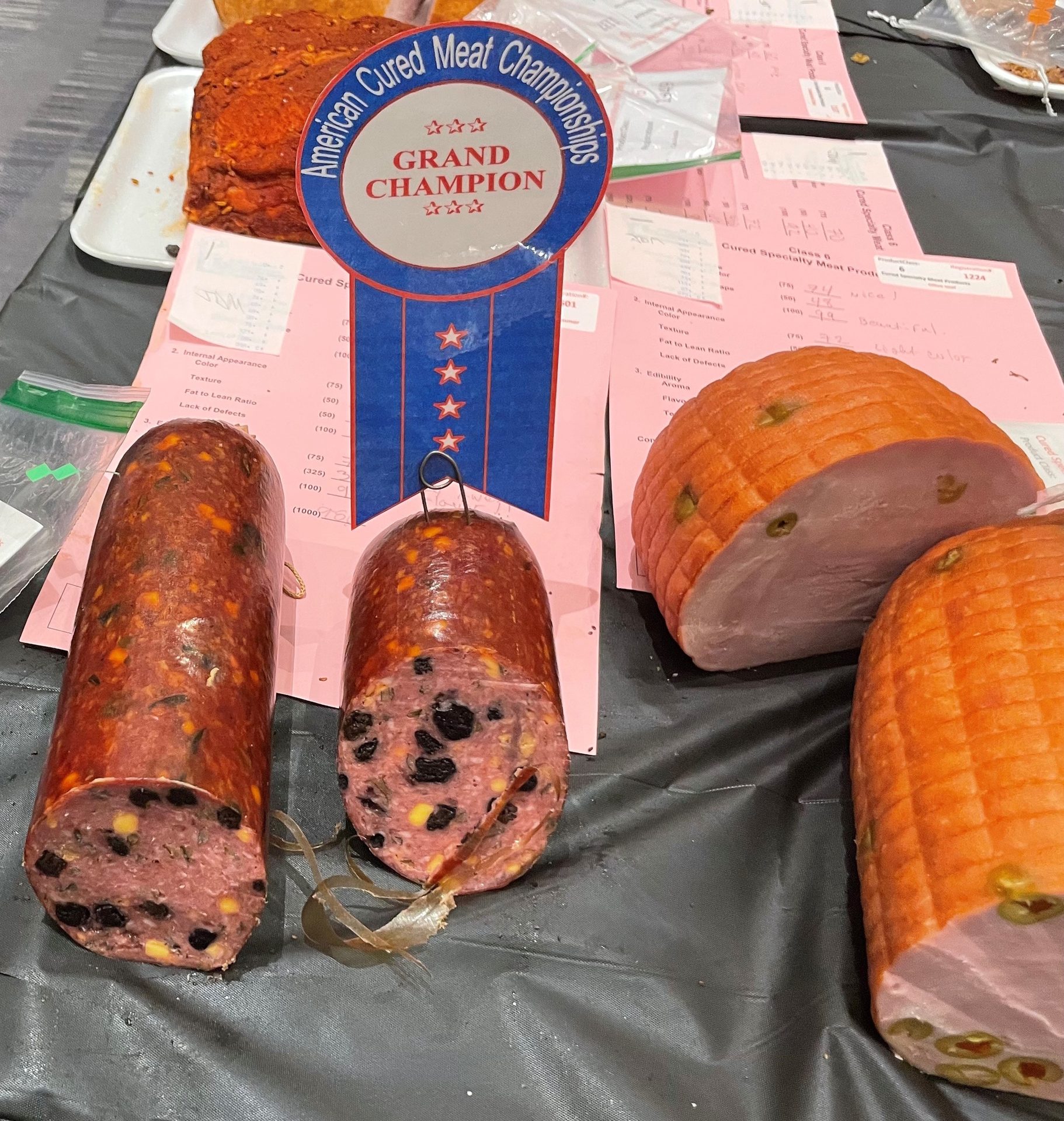 Grand Champion cured meats (sausage, ham) at American Cured Meat Championships.
