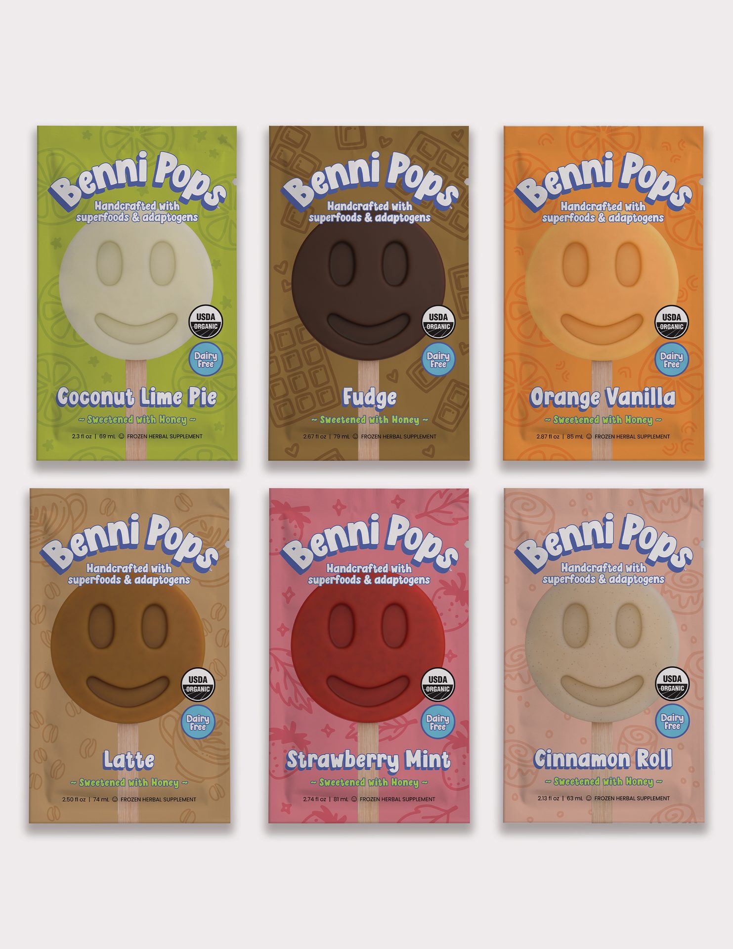 Six Benni Pops superfood popsicles, smiley-faced, organic, dairy-free in various flavors.