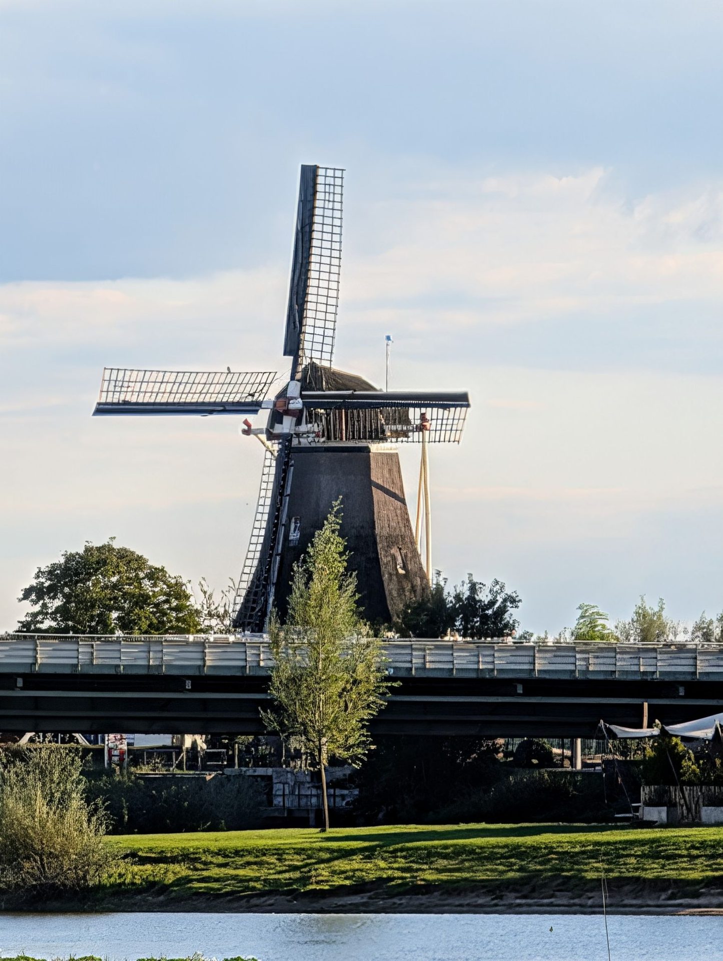 Natural landscape, Sky, Windmill, Cloud, Plant, Water, Mill, Tree