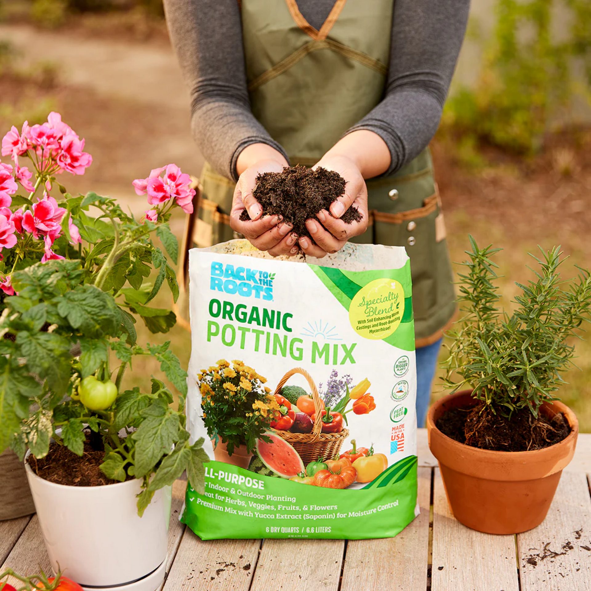 Person grabbing potting mix from package