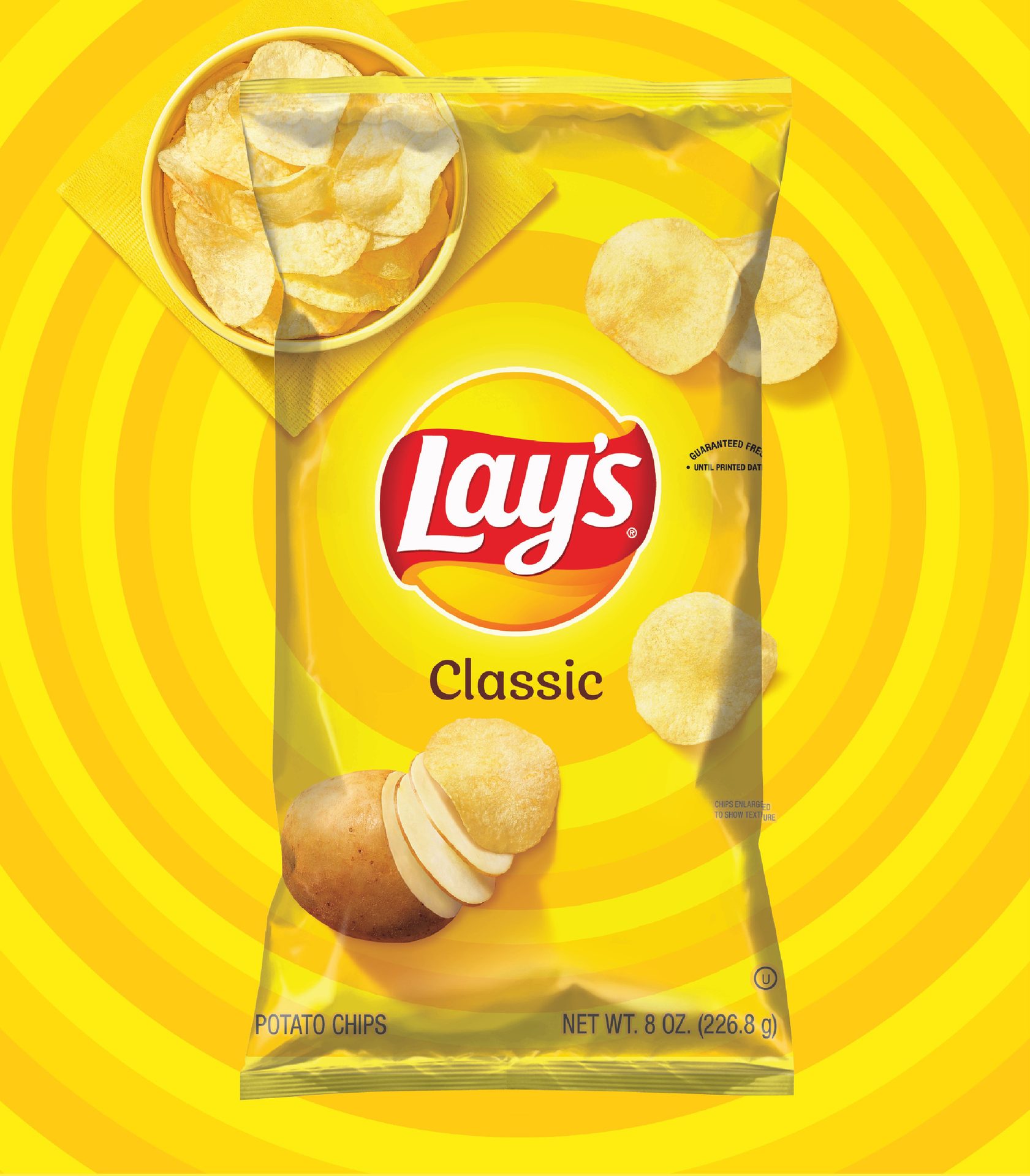 Yellow Lay's Classic potato chips bag with chips and a sliced potato.