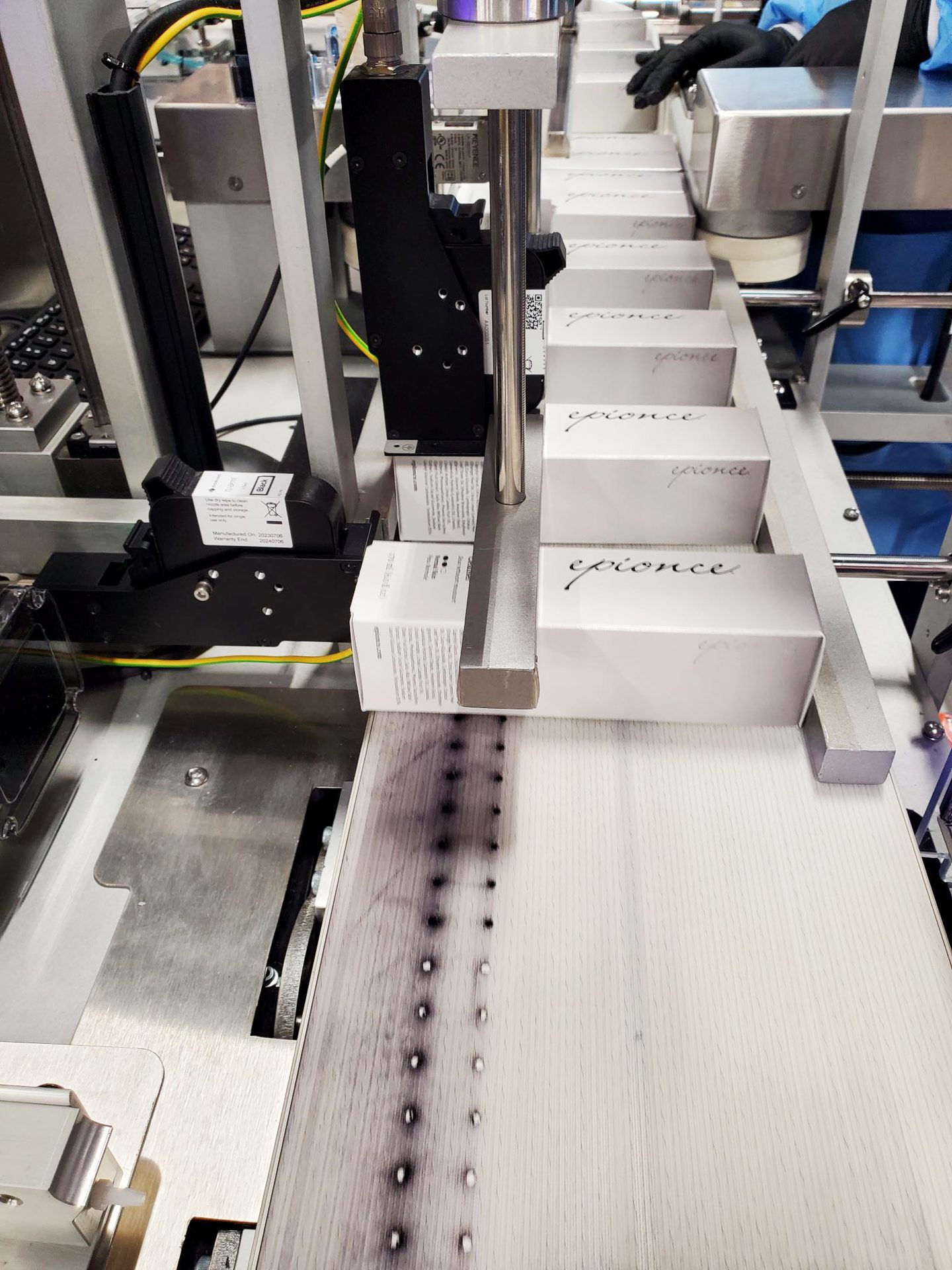 Epionce skin care products on a conveyor belt