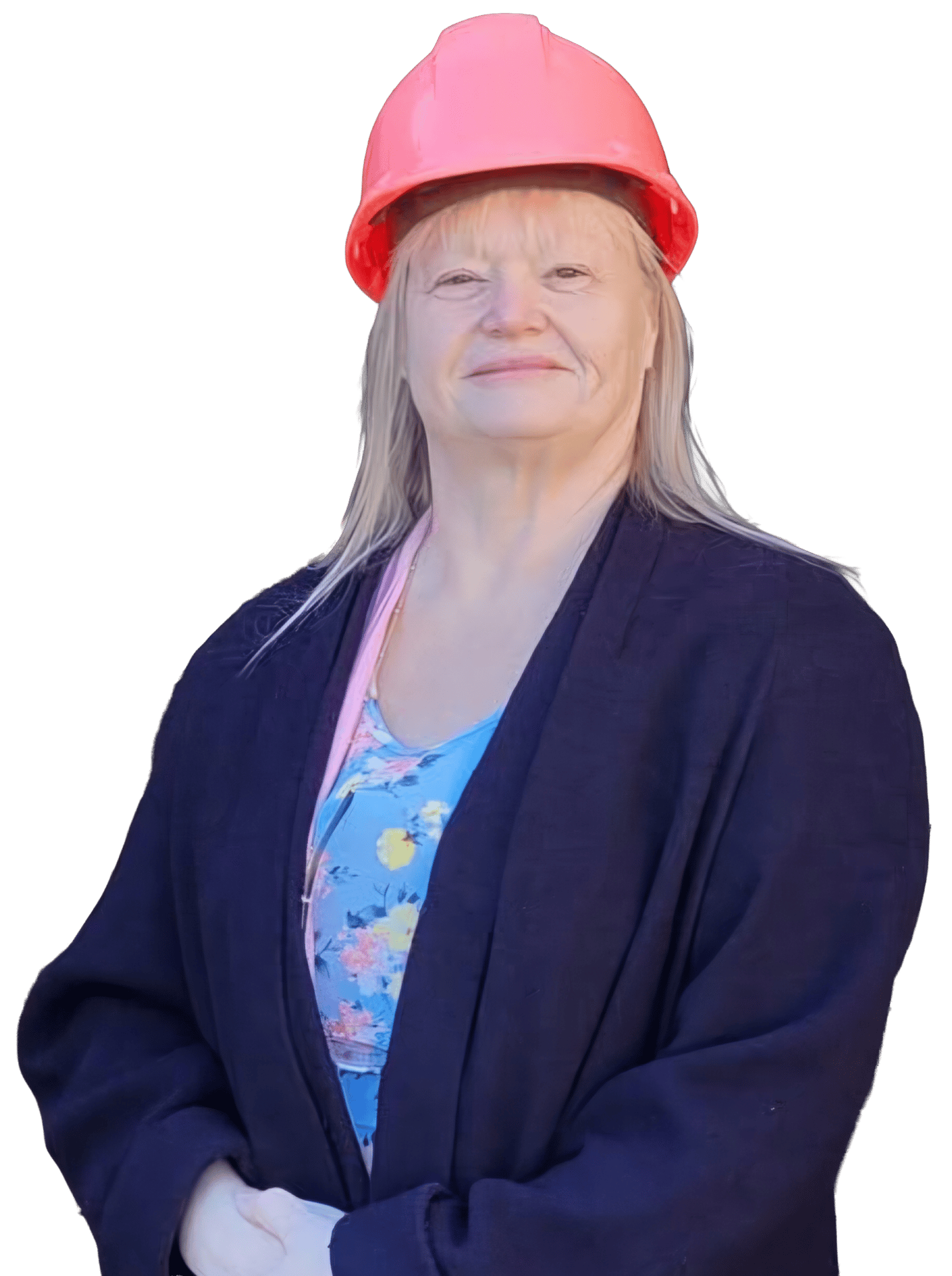 A smiling woman with blonde hair wearing a pink hard hat, blue floral top, and dark cardigan.