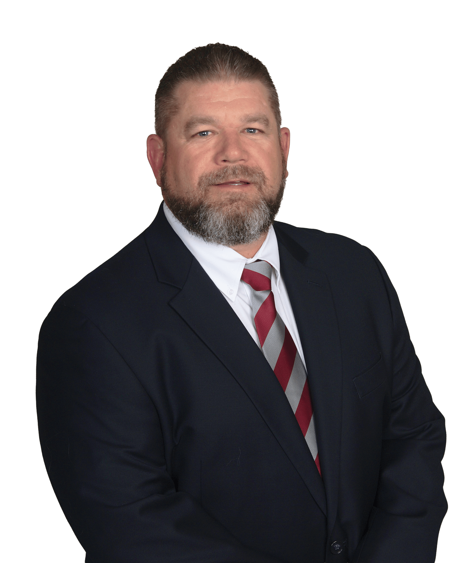 Confident man in a dark suit, red and gray striped tie, and beard, looking at camera.