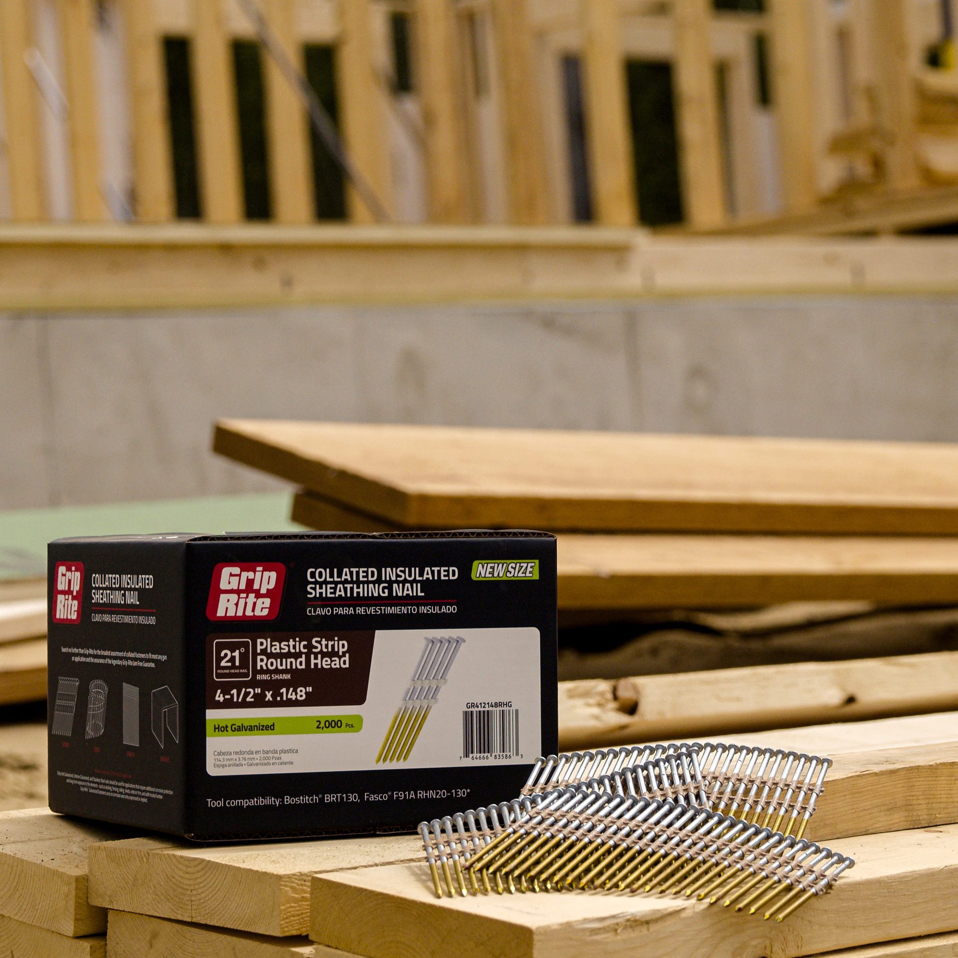 Box of Grip Rite collated sheathing nails and loose nails on wooden planks at a construction site.