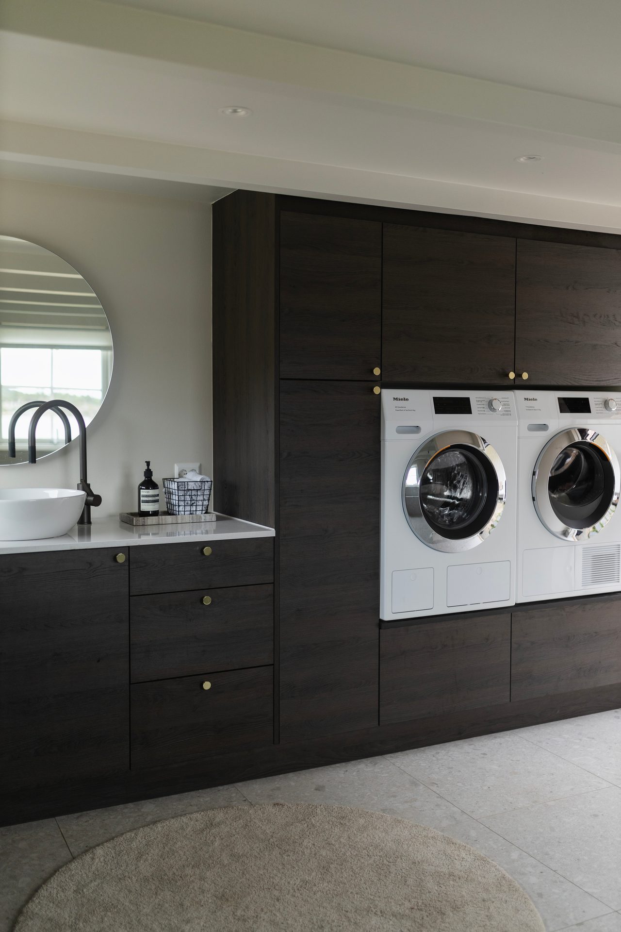 Laundry room, Washing machine, Clothes dryer, Interior design, Cabinetry, White, Countertop, Sink, Lighting, Drawer