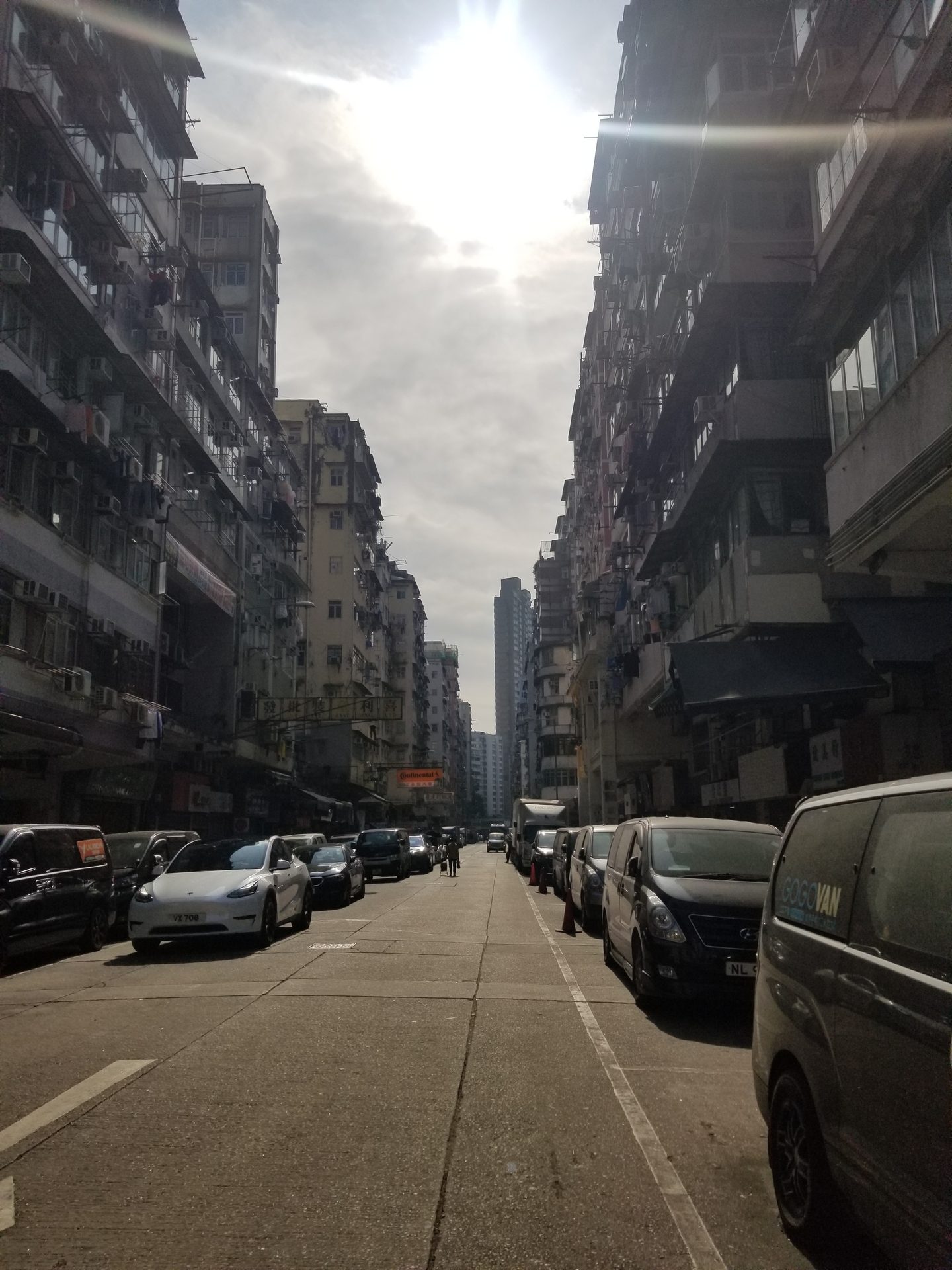 Land vehicle, Road surface, Car, Wheel, Tire, Sky, Cloud, Building, Infrastructure