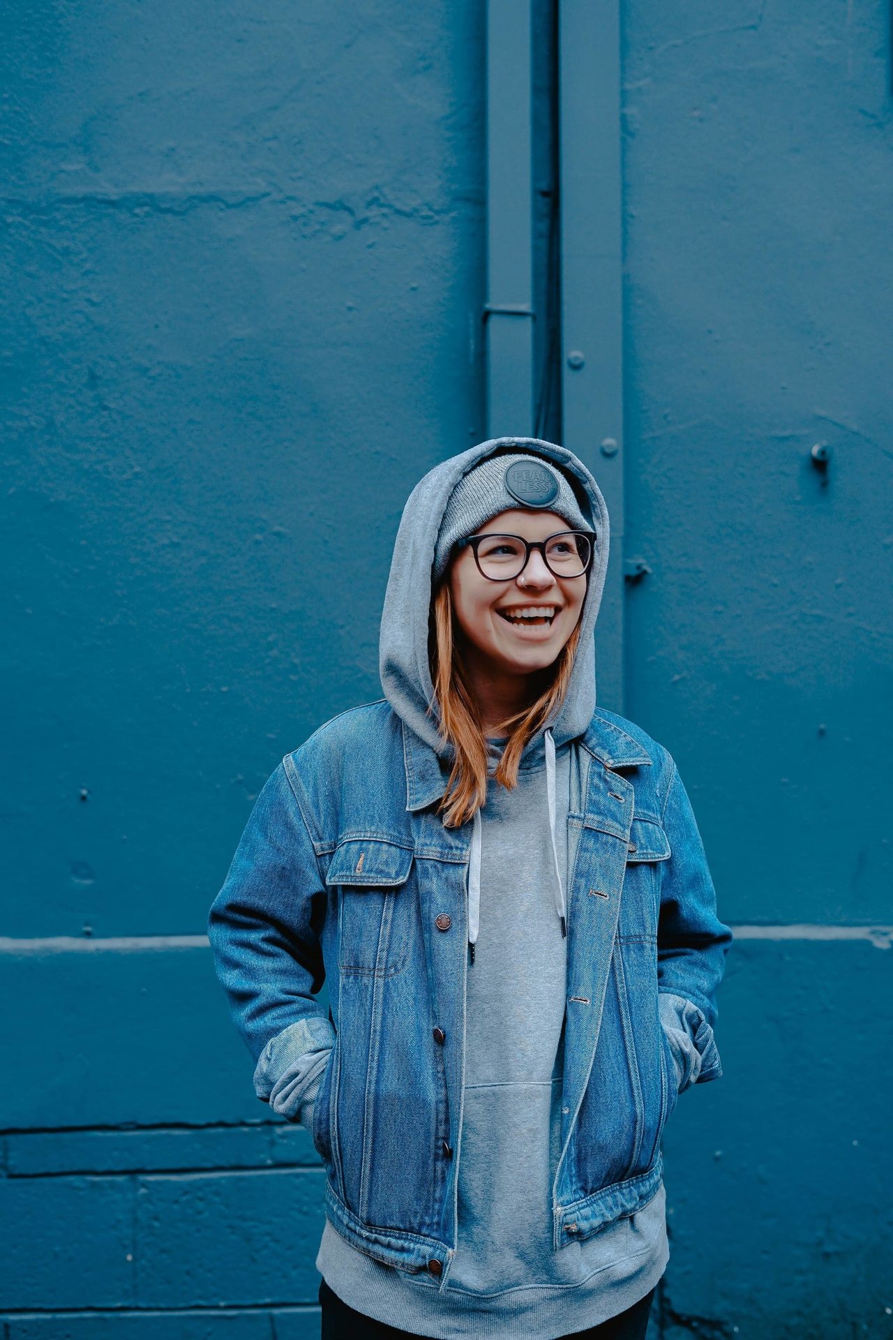 Street fashion, Smile, Blue, Azure, Sleeve, Standing, Gesture, Grey, Happy, Headgear