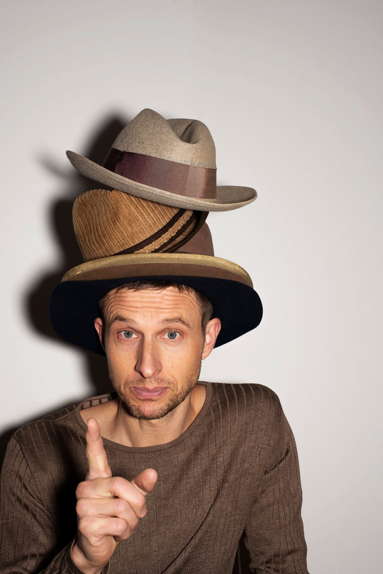 Facial expression, Sun hat, Flash photography, Clothing, Chin, Fedora, Neck, Sleeve, Gesture