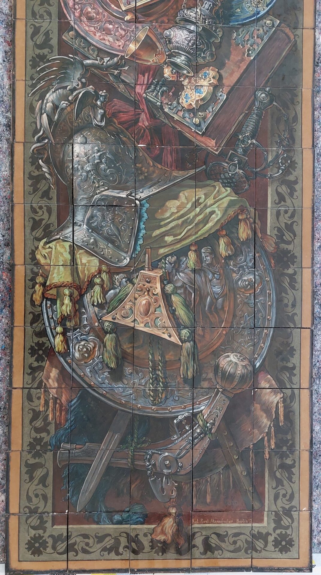 Ornate still life on tiles: armor, dragon helmet, shield, sword, book, chalice, by KPM Berlin 1891.