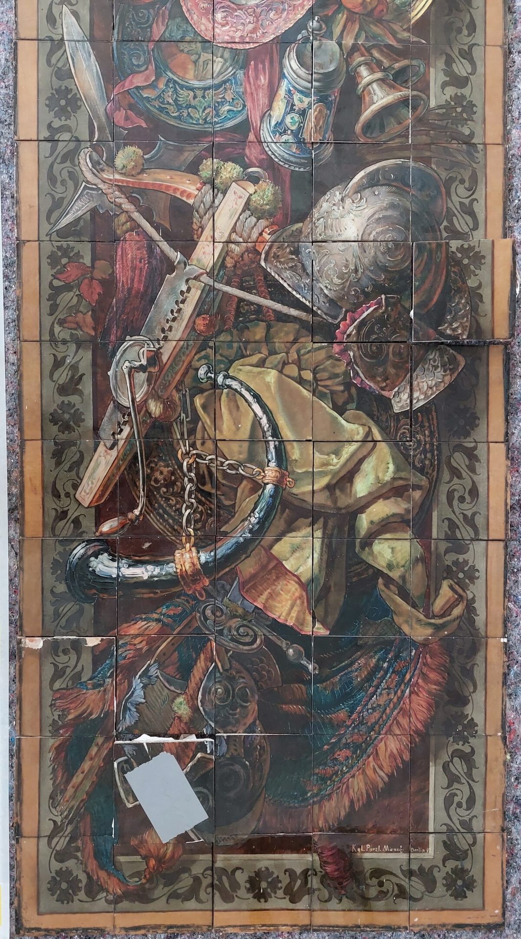 Detailed tiled still life of historical items: sword, crossbow, helmet, tankard, horn, and ornate fabric.