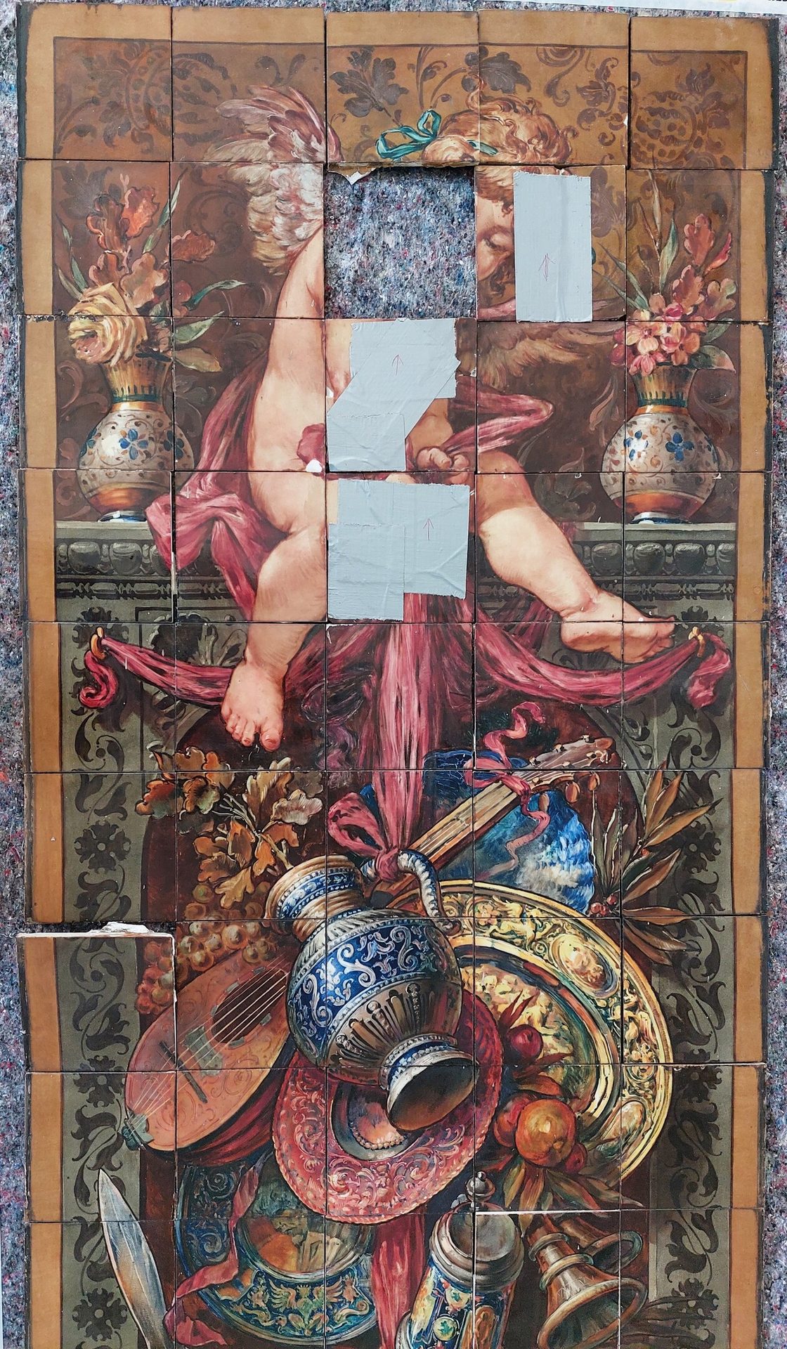 Damaged tiled mural of a cherub and still life with flowers, fruit, instruments, and pitchers.