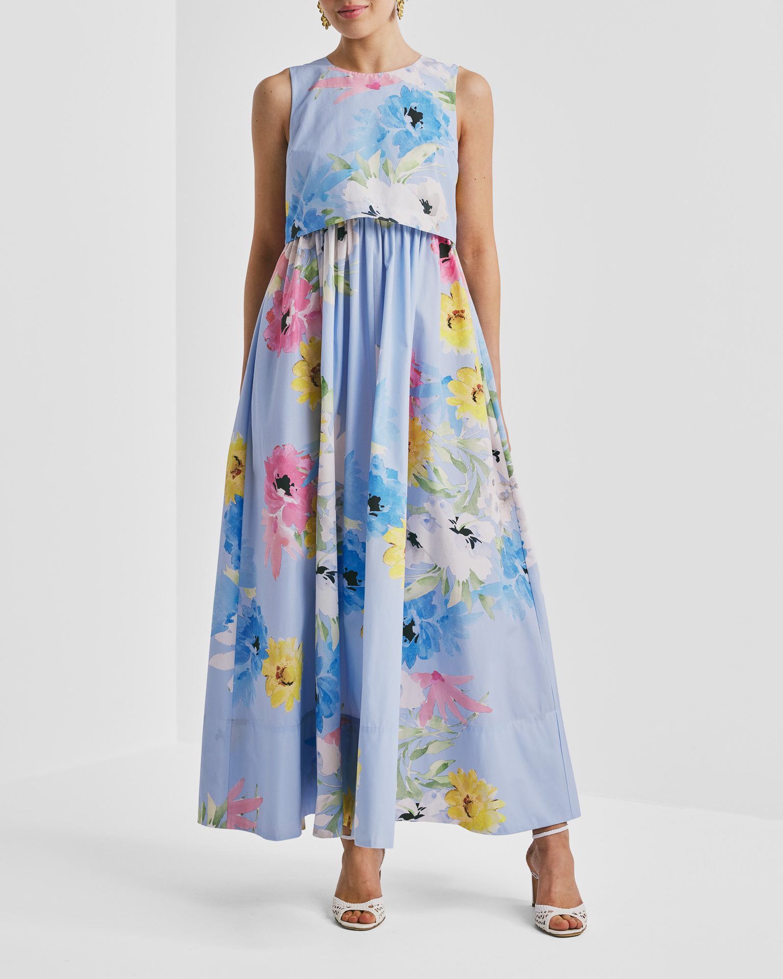 Light blue floral maxi dress with a layered top, featuring pink, yellow, and blue flowers.
