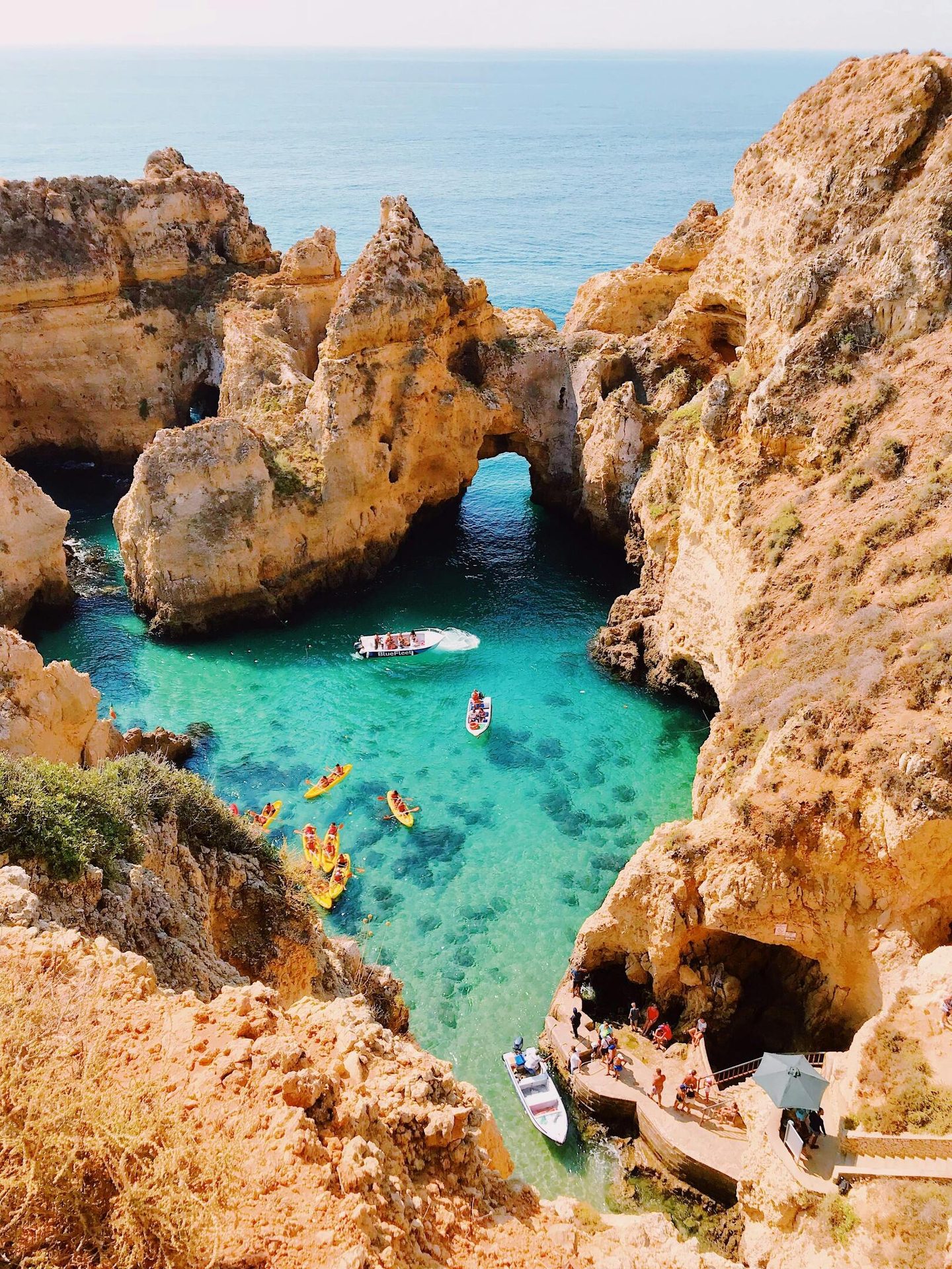 Coastal and oceanic landforms, Body of water, Natural landscape, Sky, Azure, Boat, Watercourse, Terrain, Travel
