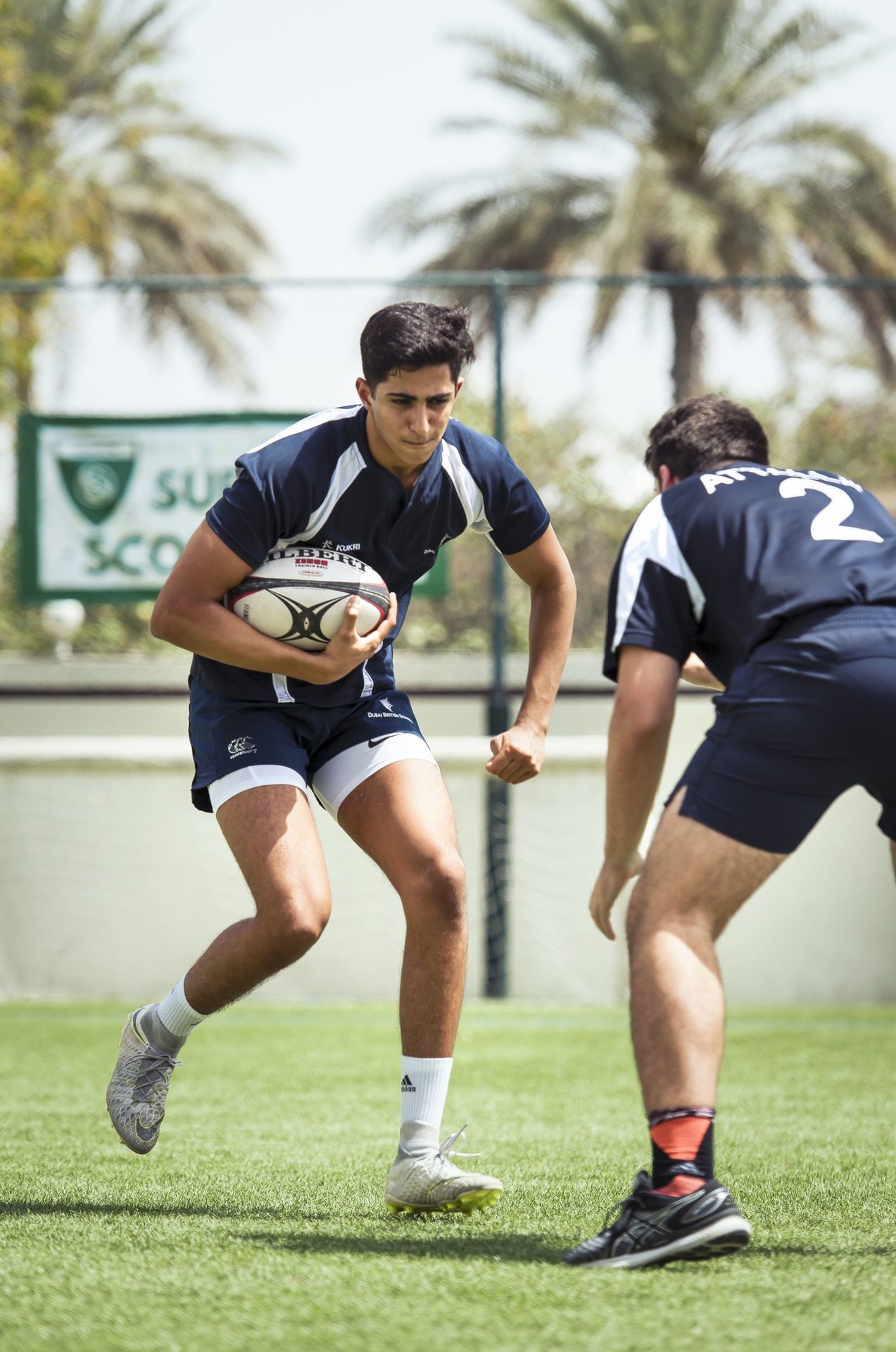 Rugby league sevens, Sports uniform, Footwear, Shorts, Shoe, Sky, Ball, Tree