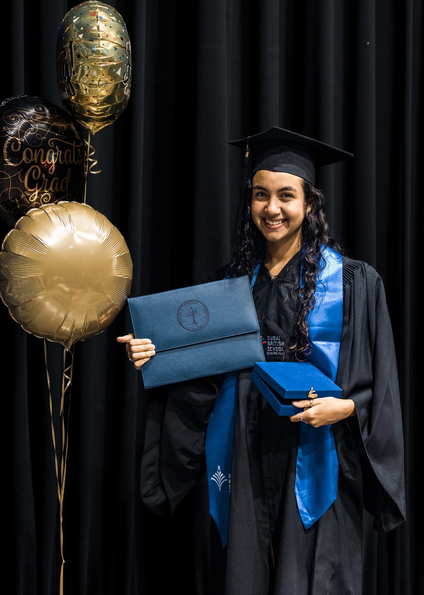 Clothing, Smile, Mortarboard, Gesture, Headgear, Scholar