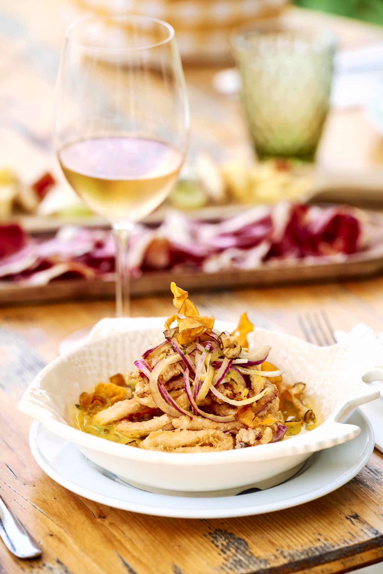 Crispy fried fish or calamari with onions, white wine, and charcuterie board.