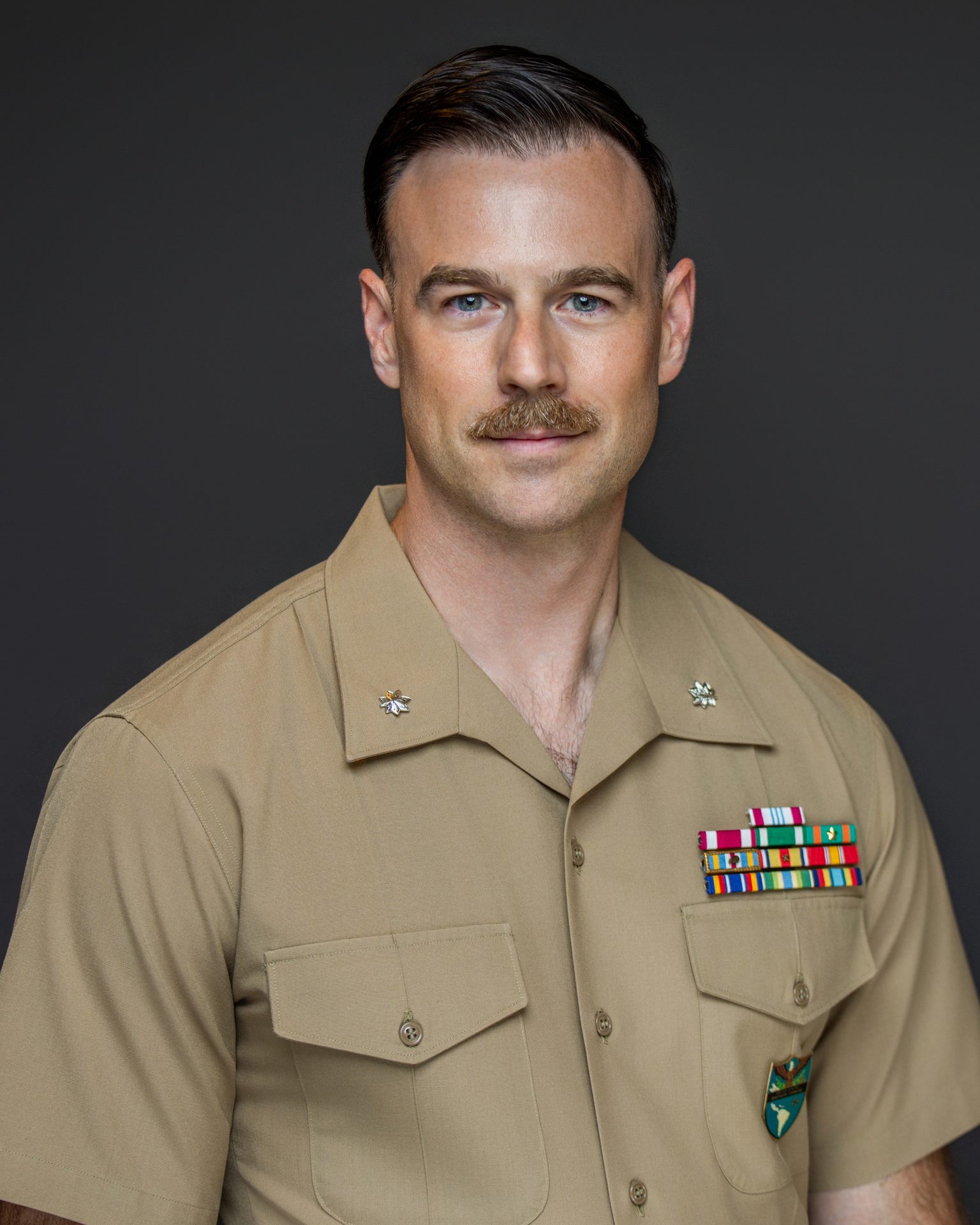 Military man with mustache in tan uniform with insignia and ribbons. Professional headshots, Corporate headshot photography, Business portraits, Executive headshots, Personal branding photos, LinkedIn profile pictures, Actor headshots, Model portfolio headshots, Creative headshot photography, Studio headshots, Outdoor headshots, Environmental portraits, Headshot retouching, Team headshots, Headshot sessions, Headshot lighting techniques, Natural light headshots, Headshot poses, Corporate branding photos, Professional profile photos, actor headshots, model headshots, executive portraits, business headshots, studio headshots, best headshots, headshot prices, corporate headshot photographer, headshot studio, professional headshot photographer, headshot photographer near me, headshot photography near me, headshots near me, real estate headshots near me, professional headshots, corporate photoshoot, professional business photo, corporate photography, corporate headshots, headshot photography, headshot photo, best professional headshots, professional headshot photographer near me, female professional headshots, professional headshots near me, business headshots near me, modern headshots, headshot prices near me, get head shots, commercial headshots, realtor headshots, linkedin headshot, professional profile picture, professional head shot, conference headshots, head shot near me, professional photo for linkedin, professional business photos, real estate headshots
