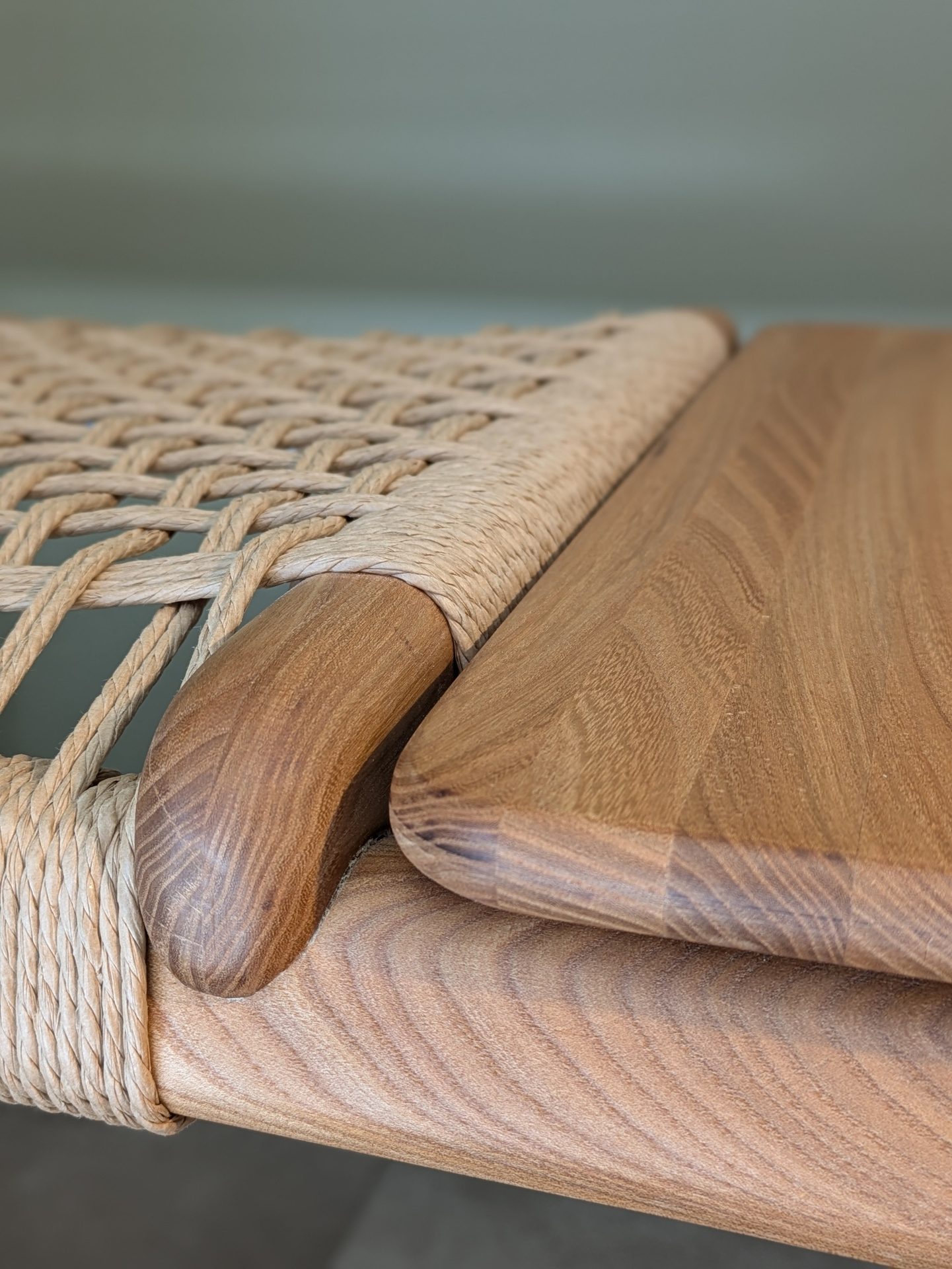 Close-up of a furniture detail, showing textured woven rope next to smooth, natural wood grains in a sophisticated design.