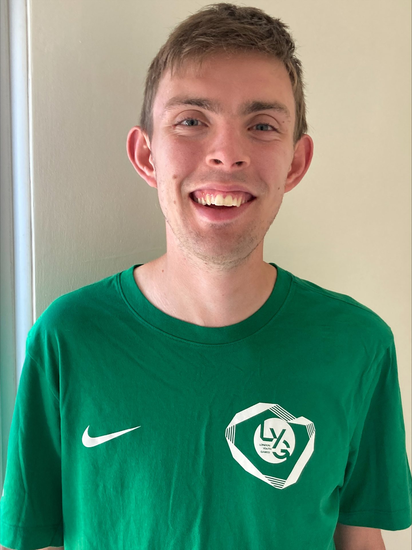 White male smiling wearing a London Youth Games Inclusive Coaches T-Shirt