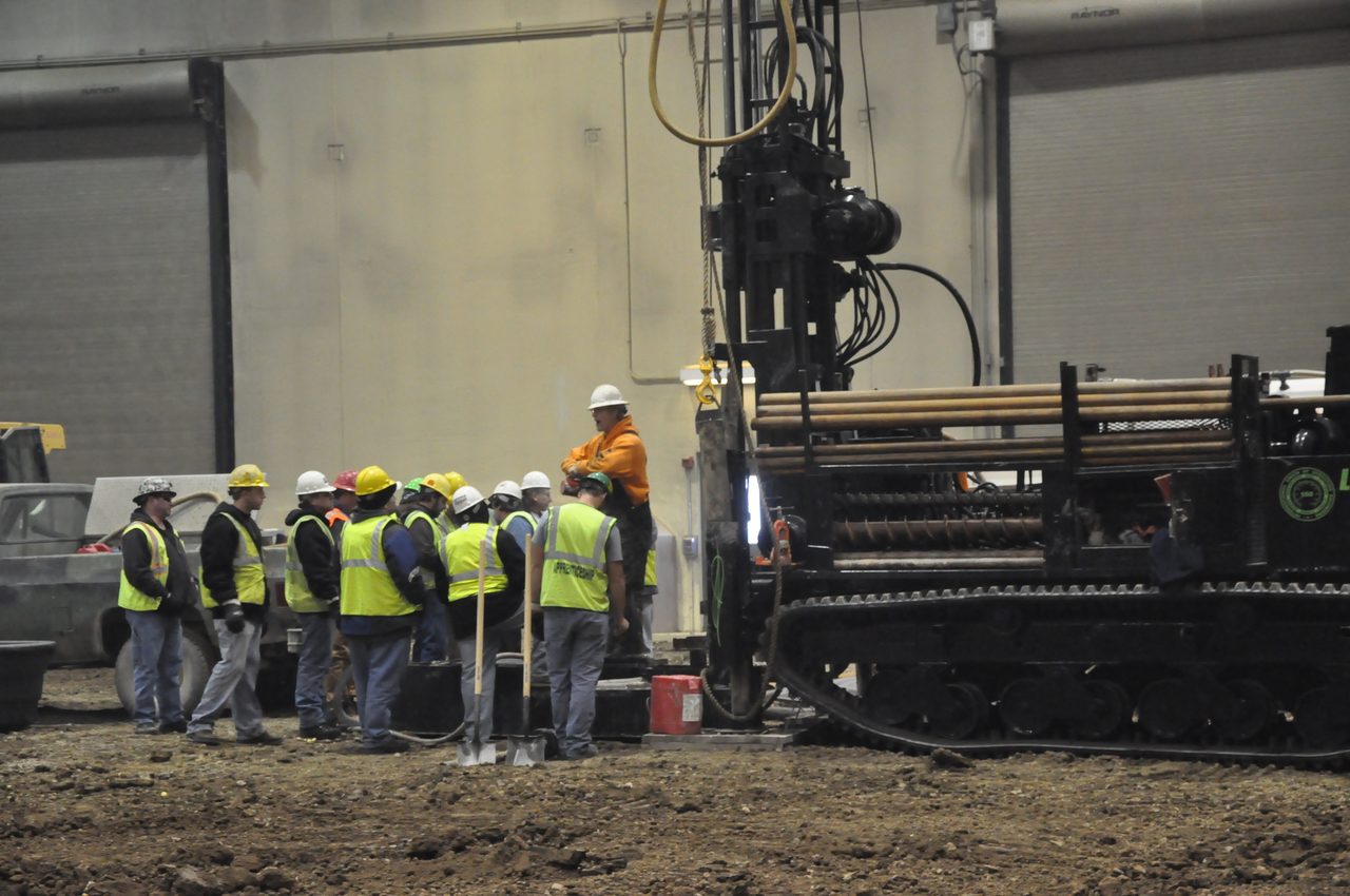 Hard hat, High-visibility clothing, Wheel, Tire, Helmet, Workwear, Vehicle, Tradesman, Asphalt, Engineer